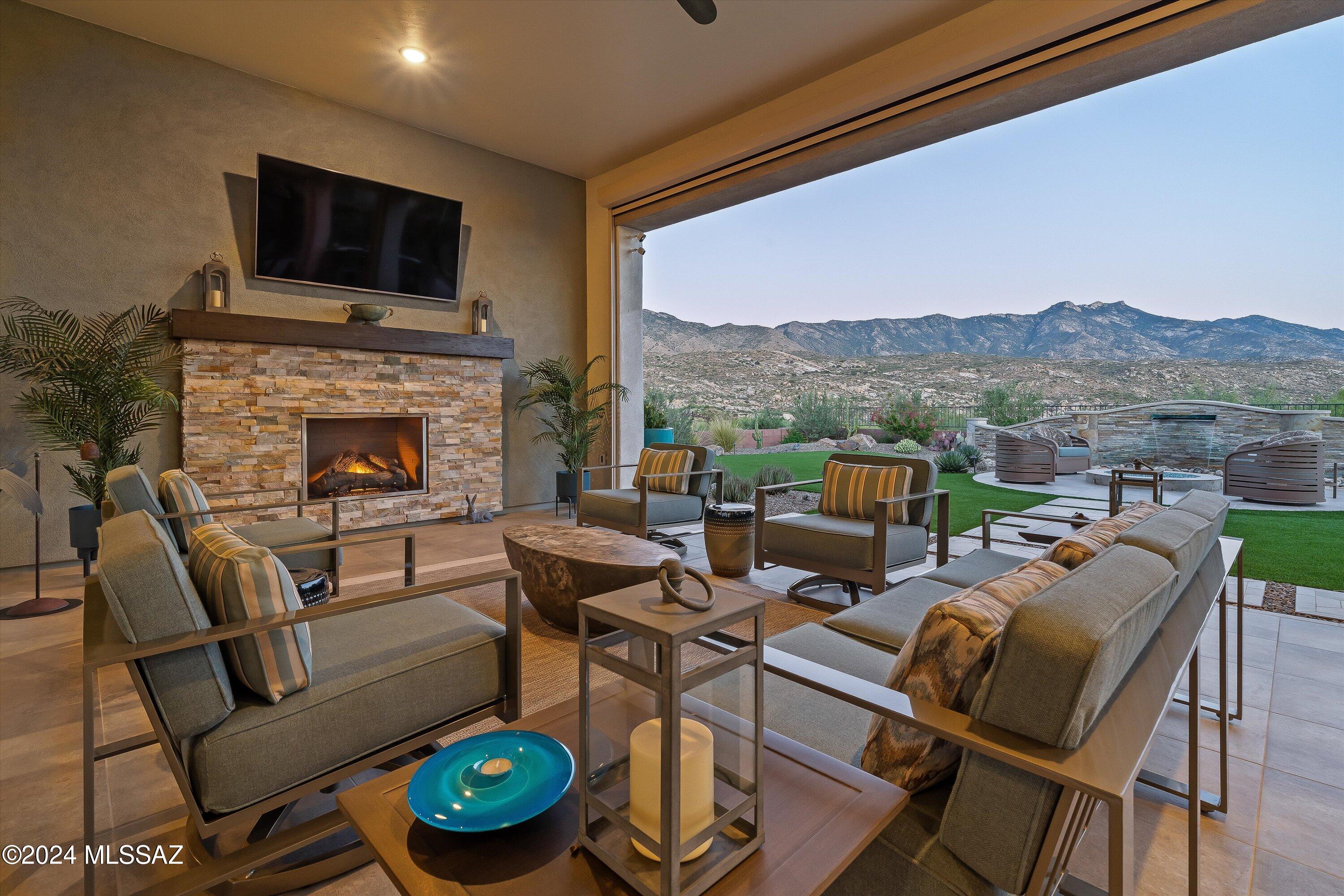 Stunning Home in The Preserve, SaddleBrooke. Discover luxury living on this elevated golf course lot showcasing breathtaking Catalina Mtn views throughout home. Three spacious bedroom suites and den w/custom built-ins, offering comfort & functionality. The award winning landscape design & outdoor living spaces are truly exceptional: porcelain tile patio, natural stone water feature & bar w/built-in grill, firepit, putting green, billiard table & ramada. Spacious covered patio w/retractable screens, stone fireplace w/TV & dining area. INSIDE, the great room custom stacked natural stone wall with TV and linear fireplace w/passive heating highlights lighted display niches. Kitchen has island w/seating, wet bar, double oven, gas cooktop, butler pantry has wine fridge & MW, walk-in pantry. The extended three-car garage includes mini-split, built-in cabinets, updated epoxy floor, EV charger, tankless water heater, utility sink, workbench and refrigerator. The gated front patio adds even more charm, providing an elevated space to relax, listen to the water fountain and enjoy stunning mountain views. Rear patio includes tile area for dance floor.