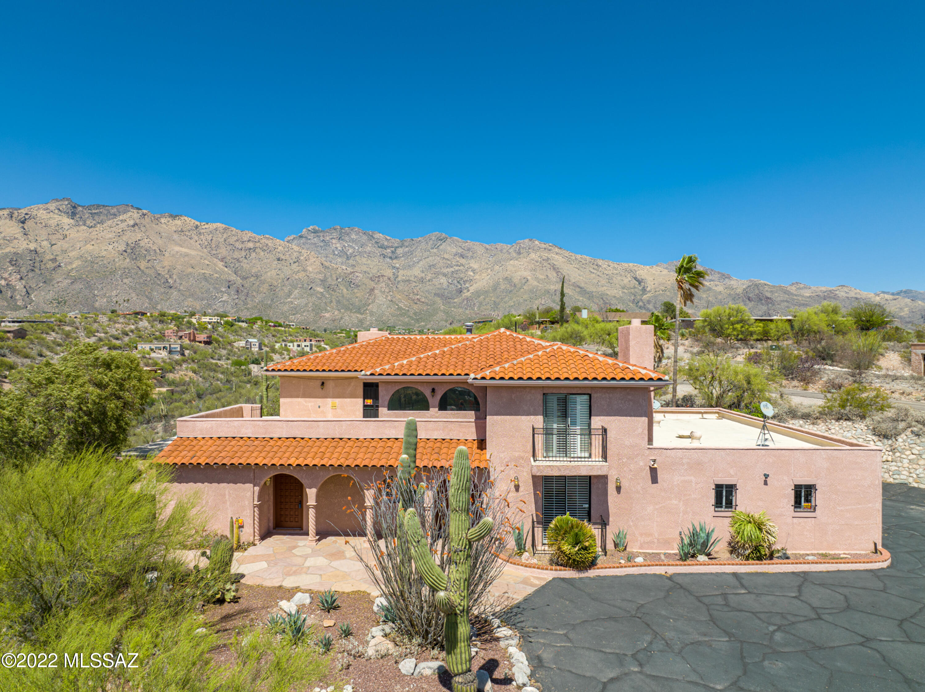 Unique Opportunity! Catalina Foothills. Enjoy the serenity of breathtaking, unobstructed views of the Catalina Mountains and twinkling city lights.
Double entrance doors take you to the first level, leading to a double-height entry foyer with living and family rooms, wood burning fireplaces, formal dining, recreation/game room with pool table and a wet bar.
The upper level includes four bedrooms, all en-suites with views. Retreat to the primary suite with ample space including a large bathroom with double vanities, jacuzzi tub and a private balcony with city views. The home also features a 2nd kitchen, sewing and crafts rooms. The private backyard features a built-in BBQ, pool with endless views, a 3 car garage. District 16 schools, close to Basis North & Whole Foods. HOA covers trash pick up and 24 hour security patrol. HOA information at www.cimarronfoothillshoa.org