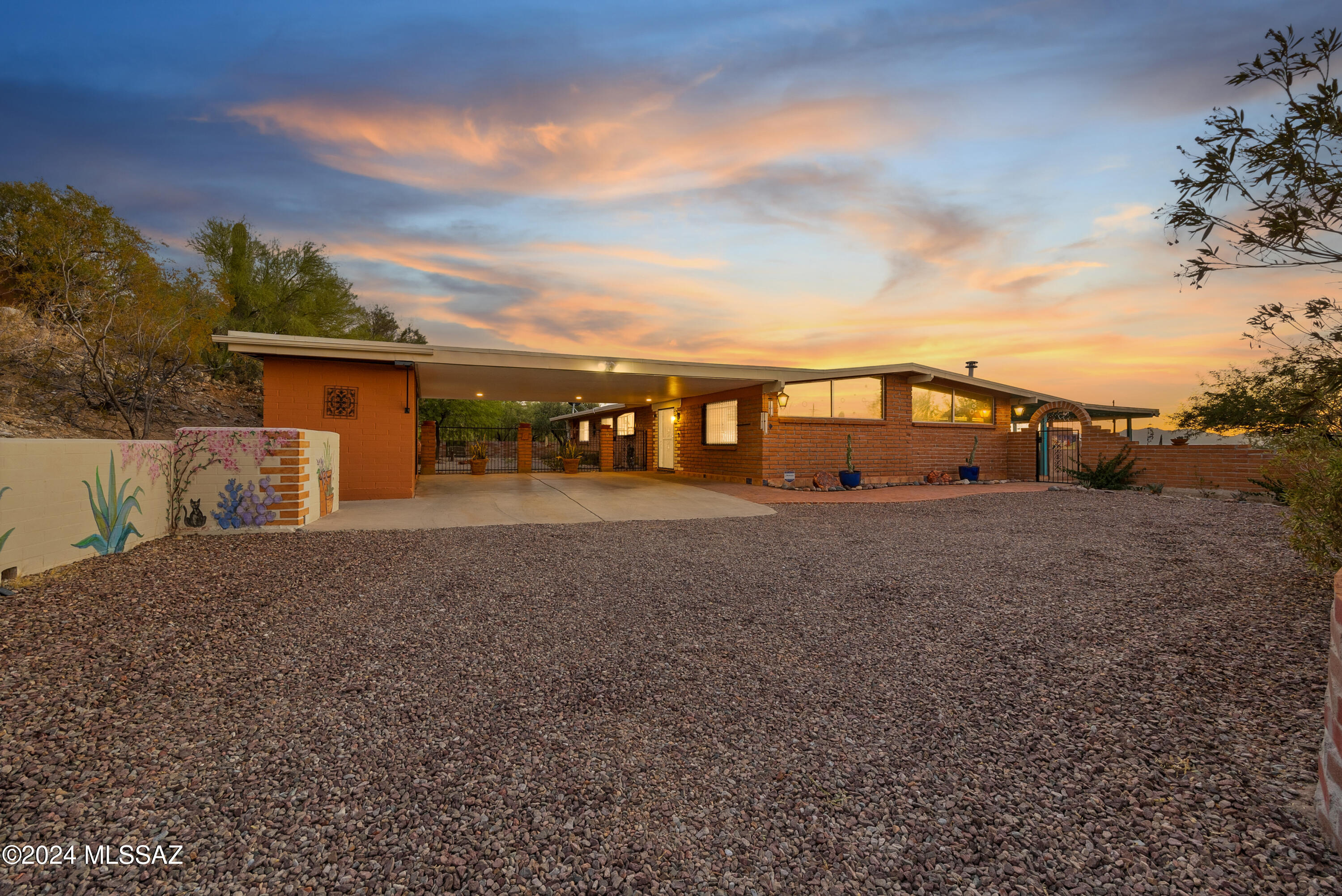 Such a charmer! This delightful 3BD/2BA burnt adobe home on a beautiful elevated view lot (.9 acre) in Suffolk Hills has the most amazing mountain & SUNSET views. This home is cozy, warm & so welcoming with views in every direction & close to everything. Not to mention incredibly PRIVATE! Kitchen is super pretty & functional with new quartz countertops, induction range, Bosch dishwasher, gorgeous birch cabinetry & tons of storage. Huge primary suite with recently remodeled primary bath which opens to the expansive patio to daydream away.  . Yard was beautifully landscaped with all easy to care for desert plants in 2022. Pool was refinished in 2023. Newer HVAC & HWH. Just imagine your evenings watching the sun set over the Tucson Mtns with a typical Tucson sunset.
Brand new washer&dryer.