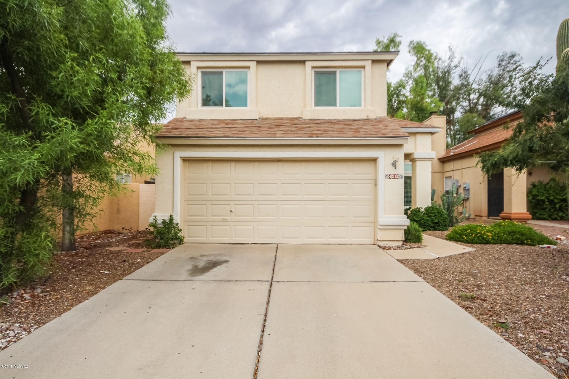 Fantastic two level Home with warm & welcoming palette, soaring ceilings, window blinds, beautiful wood floor in all the right places. Formal living/dining room. Cozy family room fireplace with patio access. Breakfast bar, black appliances, tile floor, and plenty of wood cabinets w/hardware in kitchen. Plush neutral carpet in all bedrooms, ample closets, and 2.5 baths. Vaulted ceiling in master retreat e/private en suite. Peaceful & serene backyard boasts covered patio, grassy play area, and pavered patio for dining or BBQing. This lovely Home will not last!