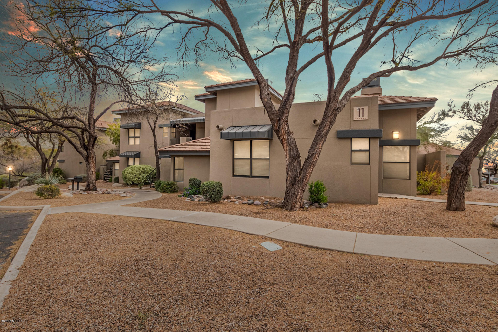 Beautiful 2 bed/2 bath condo available in highly sought after Greens at Ventana Canyon. Amazing community with meticulously maintained landscaping, breathtaking mountain views and sparkling pools and spas. Desirable parking leads to unit. Inside is bright and inviting with tasteful finishes from wall to wall. Gorgeous wood look flooring and neutral two tone paint throughout. Spacious living area features updated fireplace. Stylish modern kitchen with granite counter-tops, white cabinetry and coordinating black appliances. Two full bathrooms with granite counter-tops. Convenient indoor laundry. Secluded covered patio overlooking the pool is a great spot to relax and enjoy the desert breeze. Perfect for Airbnb or VRBO