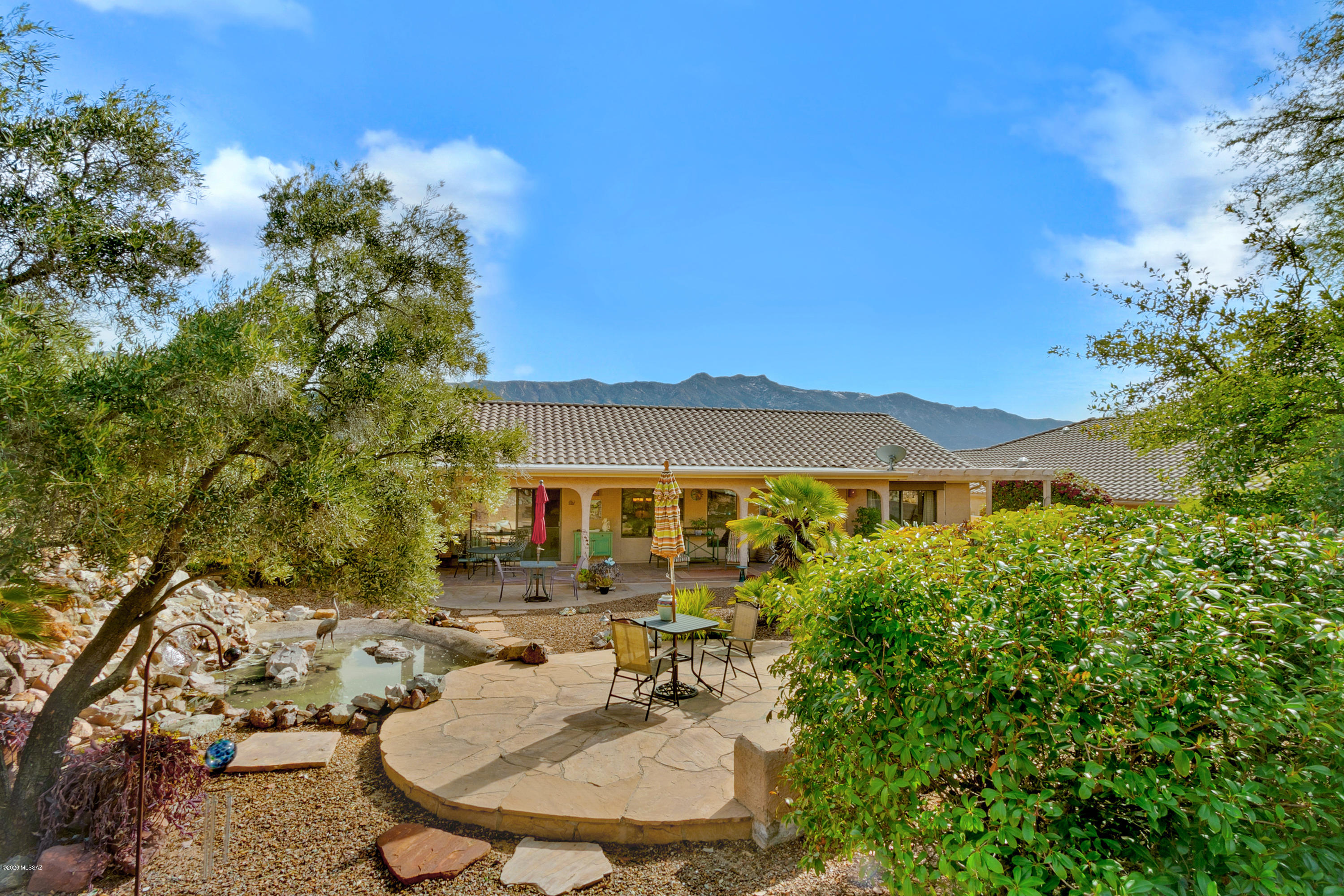 Move right in to this beautiful Topaz model with an open floorpan and updates galore! Kitchen features dazzling quartz countertops, newer SS appliances and LK sink. Plenty of room to live and entertain with 2 living and dining areas and workspace off of kitchen. Your guests will love staying with you in the roomy guest bedroom that exhibits prime mountain views. The spacious master bedroom features access to gorgeous  backyard and light-filled master bath with large closet. This oversized lot is complete with lush landscaping and your own private waterfall and pond! Wonderfully maintained, this home also has a newer HVAC system and water heater installed in 2017/2018. Enjoy all of the amenities Saddlebrooke has to offer including golf, rec center, tennis, pool/spa and dining. Welcome home!