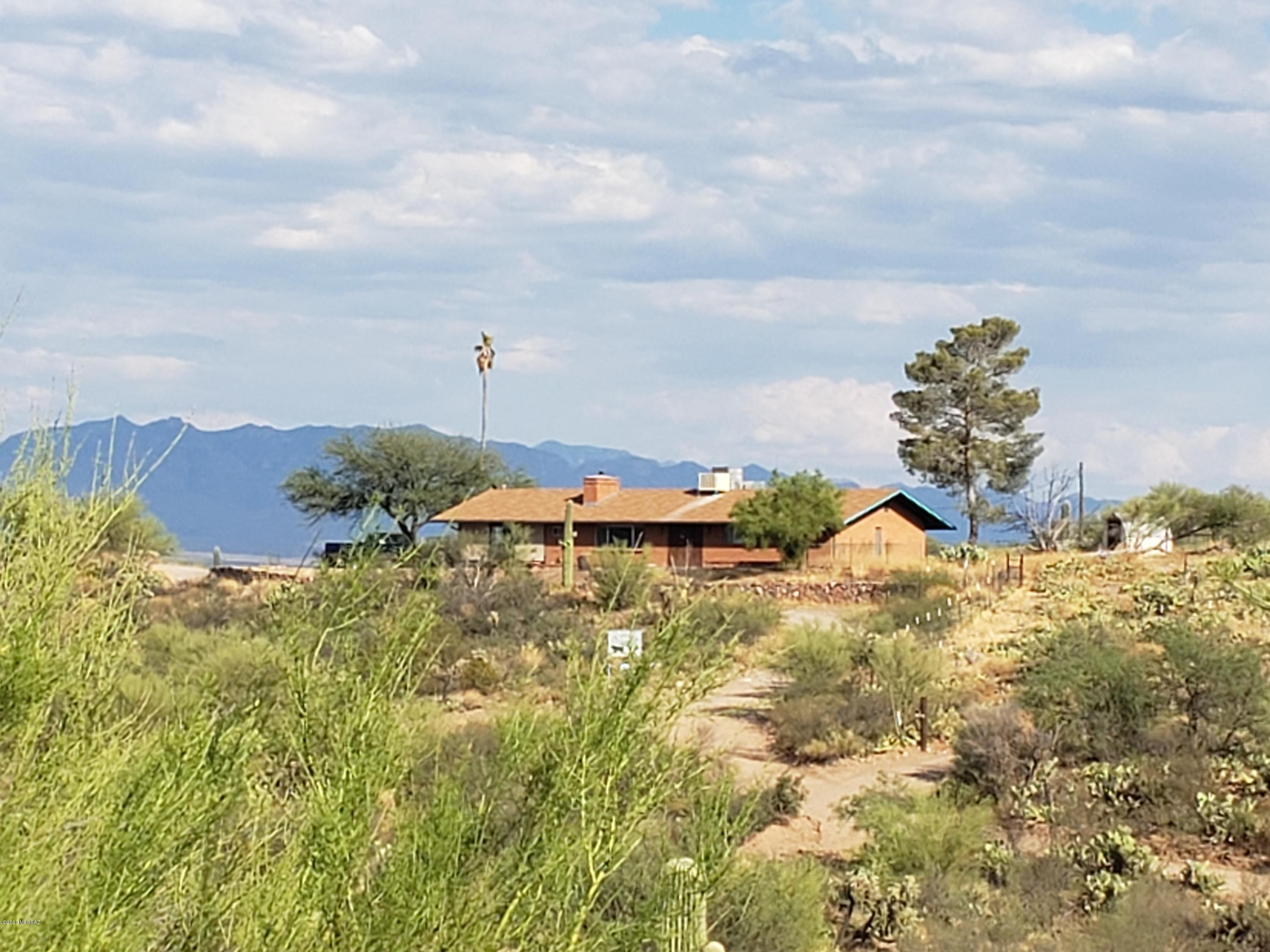 Wonderful 15 acre horse property with stunning views of the San Pedro Valley and Galiuro Mountains. Large home has updated efficient kitchen with plenty of cabinet storage. Neutral colored wood flooring/tile throughout. Large master bedroom w/walk-in closet. Master bath has tiled surround shower giving it a more modern look. Wood burning fireplace with recir fan in LR. Huge family room off kitchen offers breathtaking views. Detached carport has a store room and a large sitting deck for star gazing or entertaining. Horse facilities w/fully fenced pasture, barn w/tack room, breezeway and 3 separate stalls w/in/out areas. Double RV/hay storage shelter or more vehicle parking. 24 X 14 storage shed near barn conveys.  Lots of LED flood lighting near barn area.