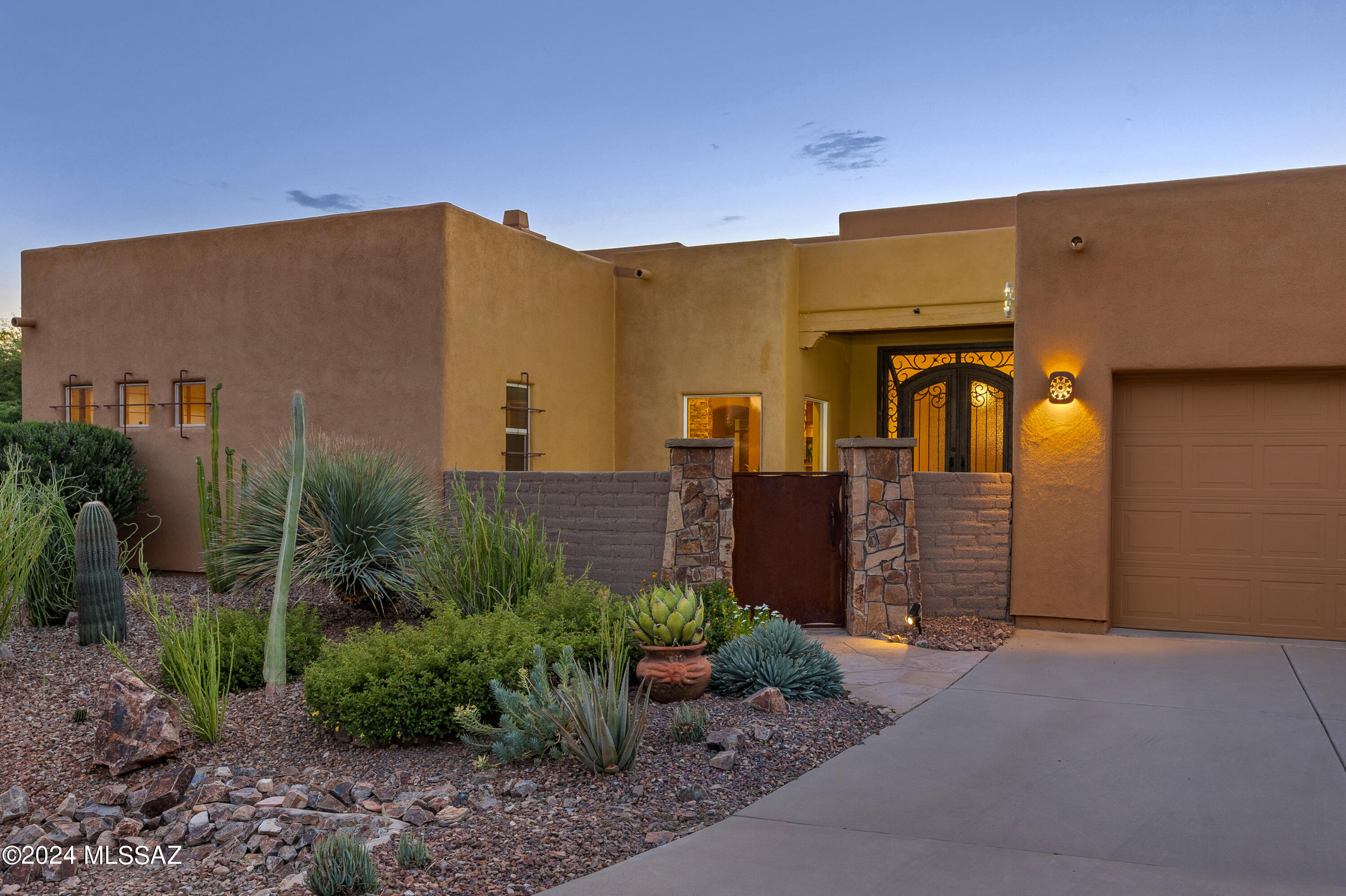 Welcome to Palisades Point, a premier gated community in Oro Valley, Arizona. As you enter the neighborhood, you're greeted by spectacular, unobstructed views of the majestic Catalina Mountains, complemented by a strong sense of pride in ownership.This home is perfectly positioned to capture these stunning vistas. The southeast-facing backyard offers panoramic mountain views, a sparkling pool, a relaxing hot tub, and a cascading waterfall - your private desert oasis. The gourmet kitchen is a chef's dream, featuring a Sub-Zero refrigerator and a top-tier, commercial-grade Capital stove. Expansive cabinetry and a large prep island provide ample space for cooking and entertaining. The home also boasts multiple luxurious spaces, including a formal dining room, a great room with... a full bar and cozy fireplace, and a living room where you can enjoy both TV and mountain views.

The main house offers three spacious bedrooms, each with direct access to outdoor patios, plus a dedicated office space, seamlessly blending indoor and outdoor living. The owner's suite serves as a tranquil retreat, featuring a stunning rustic floor-to-ceiling headboard and a recently remodeled spa-like bathroom.

For car enthusiasts or hobbyists, the property includes five garage spaces and a large workshop area, perfect for any project or craft. The attached Craft Room offers exceptional versatility, ideal for hosting guests, creating a home gym, or an additional office space.

Meticulously maintained, this home is ideally located near world-class golf courses, shopping, dining, and parks, offering the best of Southern Arizona living.