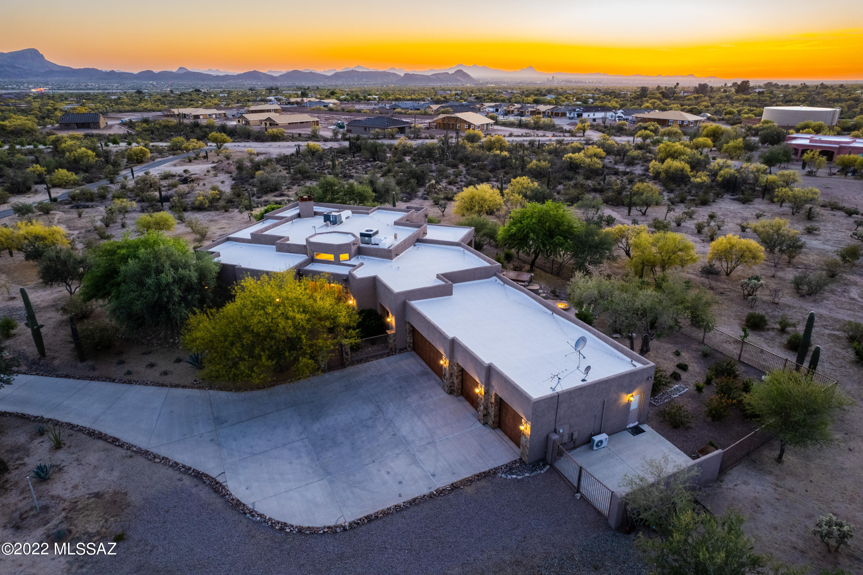 NORTHWEST GEM! 3.3 acres custom home near I-10 & Twin Peaks, no HOA, 4,023 sq.ft. , including 4 brm each with private bath plus an office off the entryway, every bedroom has a large walk-in closet, 4 car garages with 1 bay insulated has a split AC unit can be used for workshop or an additional office, automatic gate at entrance with paved long driveway, wood fireplace in family room, kitchen with island, stainless steel appliances, granite countertops, custom cabinets, tile thru-out, high ceilings and oversized fans & doors, 2 separate patios with gorgeous mountain views & evening sunset, back yard has a built-in BBQ, firepit, hot tub & waterfall feature, plenty of room to add a pool & RV parking. WITH YOUR IMAGINATION, YOU CAN MAKE THIS YOUR OWN PRIVATE DESERT OASIS!