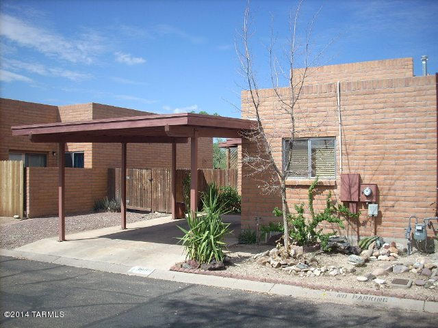 This patio home is a must see with the beautiful entry into the home, tile flooring throughout, vaulted ceilings, slate counters in the kitchen and a large gas fireplace.  Entertaining is easy with the two private patios with beautiful views of the sunsets.  This home is located close to downtown Tucson, UofA, the mall and more! The refrigerator, washer and dryer are included with this home.   This home can be rented for 12 months or longer.