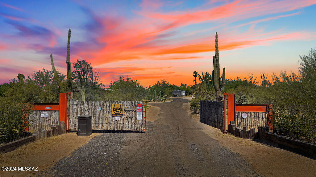 If you love horses, this property is everything you've been looking for!  With sprawling mountain views and true south western charm, this 10 acre ranch in NW Tucson has it all.  The property features a stunning burnt adobe ranch house with open beamed wooden ceilings, exposed brick walls, multiple fireplaces, classic Saltillo tile and lovely refurbished and refinished pool with Sonoran desert landscaping. The matching guest house is truly unique.  This property features a 350 foot by 140 foot roping arena, a six stall barn, multiple corrals, a round pen, 8 outdoor Seven Peaks stalls, spacious chicken coop, large hay barn, a workshop, a shared well with one other property, large 2 bay RV garage with rolling doors, wine cellar and 3 car garage plus 2 carports. New roof on Casita, garage and main house.  New A/C on both houses.  This property an operating PERMITTED boarding facility.   Property is minutes from the outlet mall and I-10, yet seems a world away from civilization.