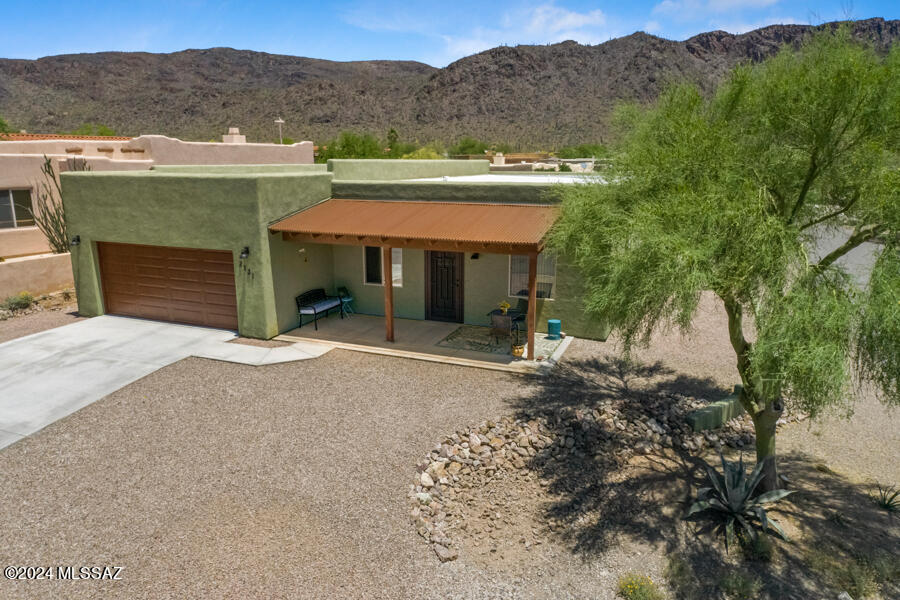A NEWER Custom built home, clean finishes, open concept with latest kitchen and cabinet design, generous bathrooms, all split bedrooms, wide doorways and hallway. Interior design makes great use of space, includes plenty of storage, primary suite offers a HUGE walk-in closet. Everything you want - with no wasted space. Rear covered patio overlooks the spectacular Tucson Mountains. This beautiful home is complete - AND maintenance free.  Lovely colorful landscaping completes the picture.