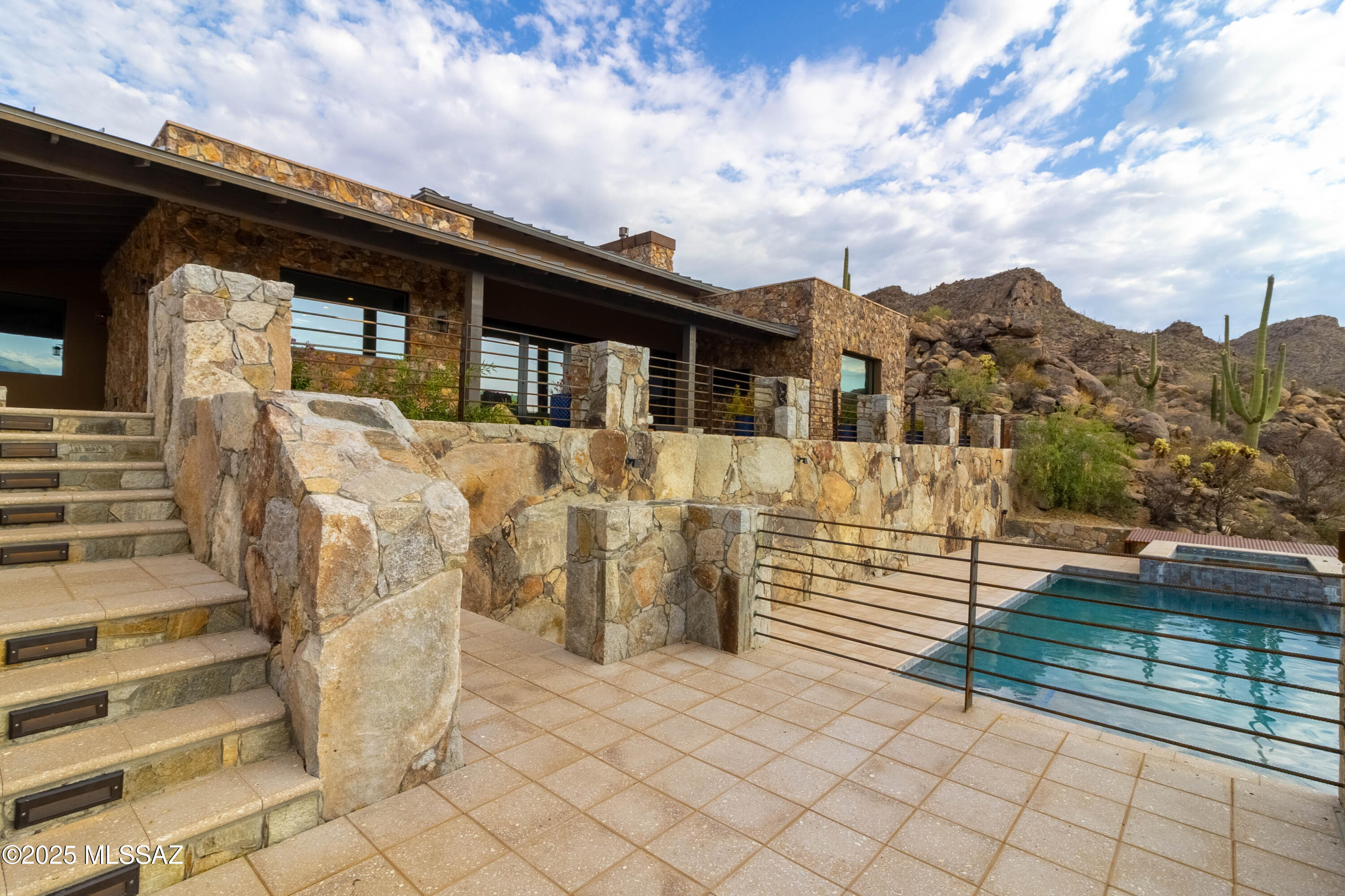 Live where others can only dream.

Tucked beyond the iconic tunnel at Saguaro Ranch, this rare offering blends award-winning design, mountain-sculpted privacy, and a lifestyle reserved for the few. Gaze out over the Tortolitas and Catalinas from a residence seamlessly carved into the desert. Enjoy curated touches like a dramatic wine cellar built directly into the rock — a bold fusion of nature and luxury.

Set in one of Arizona's most secure and prestigious gated communities, this move-in-ready home is your key to the best-kept secret in the Southwest. Whether you're entertaining in style or retreating in peace, this is more than a home — it's an experience.