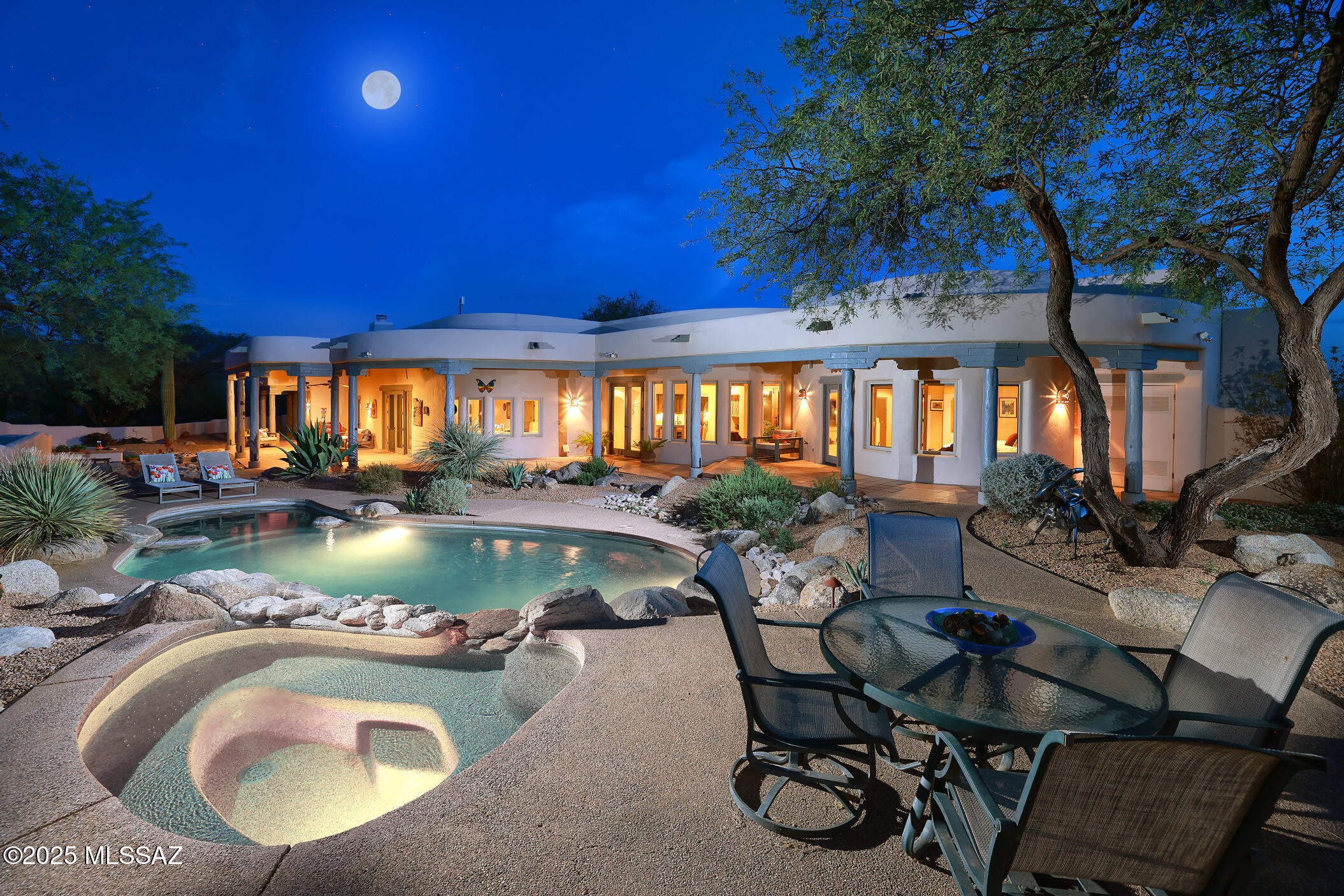 Authentic Ray Birch Home Nestled on 3.35 Acres with Breathtaking Mountain Views. This Spacious 4,205 SqFt Residence Offers 5BD/4BA & Showcases Upscale Santa Fe Charm Throughout; Kiva Fireplaces, unique Viga-Beamed Ceilings, Saltillo Tile & distinctive Saguaro Ribbed Cabinetry. Kitchen Features an Expansive Island with Bar Seating, Gas Cooktop & Panoramic Views from Bay Window. Two Luxurious Primary Suites situated on Opposite Sides of Home ensure Maximum Privacy. Your Private Outdoor Oasis is Complete with Heated Pool/Spa, Built-in BBQ Area, Cozy Kiva Fireplace & Banco Seating. The Garage Includes 2 Storage Rooms plus Heated and Cooled Studio/Workshop. Located in the Prestigious Gated Community of Sunrise Ranch, at the Base of Mt. Lemmon, w/ Hiking Trails just Steps from Your Front Door. Nestled within the exclusive, gated Sunrise Ranch community, this exceptional Ray Birch home sits on 3.35 acres of pristine desert, offering unrivaled privacy and breathtaking mountain views. Built in 1999, this residence was designed and constructed by the legendary Ray Birch for his own family, showcasing the finest elements of high-quality Santa Fe architecture. The 4,205 SqFt floor plan offers 5 spacious bedrooms, 4 luxurious bathrooms, and expansive living areas filled with custom details, such as viga beams, saguaro ribbed cabinetry, Saltillo tile flooring, and distinctive ceiling treatments.

The gourmet chef's kitchen is a highlight, boasting extensive counter space with rustic tile accents, a large center island with seating for six, a Subzero refrigerator, a convection oven, and a walk-in pantry. The open layout connects seamlessly to the family room, making it ideal for both everyday living and entertaining. The formal dining room features a built-in buffet, with an optional custom dining table that seats up to 10 guests.

The home offers two private primary suites, each with stunning mountain views, a kiva fireplace, and luxurious bathrooms with jetted tubs, oversized showers, and custom vanities. Both suites provide direct access to private patios, allowing you to enjoy the serene desert surroundings at your leisure.
Step outside to your own desert oasis. 

The expansive backyard boasts a heated Pebble-Tec pool with a large lagoon area for sunbathing, an elevated spa with a cascading rock waterfall, and a built-in BBQ area perfect for al fresco dining. Cozy banco seating surrounds the kiva fireplace, creating an inviting space for relaxation. The wrap-around covered porch provides additional outdoor living space, allowing you to enjoy the unobstructed views of the surrounding desert and mountains, plus there are over 30 Saguaro cactuses on the property.

Additional features of this remarkable home include a 3-car oversized garage with two storage rooms with shelving and a climate-controlled workshop/studio with three large windows, ideal for hobbies or creative pursuits. 

The property is beautifully landscaped with mature fruit trees, including lemon, grapefruit, and pomegranate, and offers direct access to hiking trails at the base of Mt. Lemmon. This home offers a rare combination of luxury, comfort, and location.

THE PROPERTY
> Gated Sunrise Ranch Subdivision 
> Gorgeous Mountain Views
> Built in 1999 by Ray Birch Construction, Legendary for High-Quality Santa Fe Style Homes
> This Special Home was Designed and Built for Mr. Birch's Own Family
> Centered on 3.35 Acres of Pristine Desert at the end of a long cul-de-sac
> Over 30 Saguaros on the Property
> Hike from Your Patio to Many Trails at the Base of Mt. Lemmon
> 2nd Privacy Gate at Driveway Entrance
> 3-Coat Frame Stucco
> Roof Coated and Roof Scuppers Replaced - 2024
> Freshly Painted Back Yard and Courtyard Walls - 2025 
> New Water Heaters with Recirculation Systems - 2024
> 2 New Trane HVAC's - 2020
> Oversized 3-Car Garage (1,196 Sq Ft) plus 2 Storage Rooms with Shelving
> 3rd Bay currently used as Workshop/Artist's Studio with Mini-split A/C
> Central Vacuum
> Mature Fruit Trees including Lemon, Grapefruit & Pomegranate

THE HOME
> Beautiful Hacienda Style Door Entry into Inviting Front Courtyard
> 4,205 Square Feet of Living Space 
> 5 Bedrooms and 4 Full Bathrooms
> Unique Ceiling Treatments: Viga Beams, Saguaro/Ocotillo Ribbed, Exposed Wood, and Skip-Peeled Latillas
> 3 Gas Fireplaces: Family Room, Living Room, and Primary Bedroom
> Wet bar with Mini Fridge and Saguaro Ribbed Cabinet Doors
> Solid Wood Doors Throughout Entire Home
> Knotty Solid Wood Cabinetry, many with Saguaro Rib Accents
> Saltillo Tile Flooring Throughout - Resealed 2025
> Wired for Sound - Flush Speakers in Nearly Every Room
> 2 Primary Bedroom Suites
> Inlayed Talavera Tiles and Unique Sinks are Distinctive Features in Every Bathroom
> Each Bedroom has Access to Exterior and Private Covered Patio
> Raised Counter Height in 2nd Primary Suite/Guest Quarters
> 4th and 5th Bedrooms have Off-the-Wall Beds with Desks
> Large Laundry Room with Storage Cabinets and Sink

IN THE KITCHEN 
> Gourmet/Chef's Kitchen
> Mountain Views!
> Open to Family Room
> Extensive Counter Space with Rustic Tile Accents
> Large Center Island with Seating for 6
> Subzero Integrated Wood Panel Refrigerator and Freezer
> Convection Oven and Separate Warming Drawer
> Reverse Osmosis System
> Large Walk-in Pantry
> Built-in Desk
> Formal Dining Room with Built-in Buffet - Custom Dining Table with Seating for 10 Available

PRIMARY BEDROOM SUITE
> Spectacular Mountain Views
> Kiva Fireplace
> Doorway to 5th Bedroom/Den
> Jetted Jacuzzi Tub
> Separate Vanities
> Oversized Shower with Double Shower Heads
> Walk-in Closet

BACKYARD OASIS
> Unobstructed Panoramic Views
> Wrap-Around Covered Porch 
> Heated Pebble-Tec Pool with Large Lagoon Area for Sunbathing
> Elevated Spa with Cascading Rock Waterfall
> Built-in BBQ Area with Kiva Fireplace and Cozy Banco Seating 
> Low Care Desert Landscaping