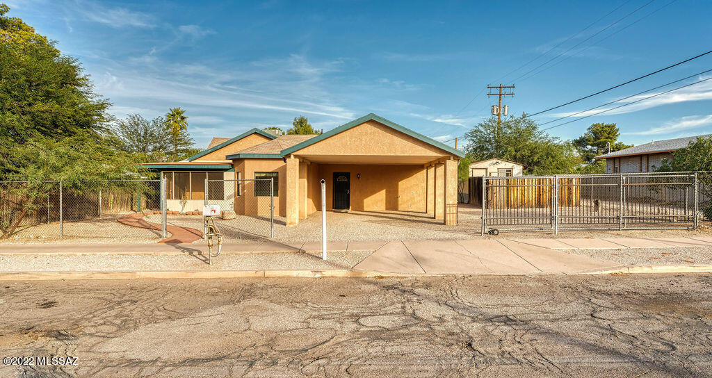 Central 3 bedroom, 2 bath home, just blocks North of the University of Arizona and West of Banner-University Medical Center Tucson.  Great family home or investment opportunity!  Low maintenance ceramic tile throughout the home.  No carpet!  Fresh interior and exterior paint makes it bright and inviting.  Enjoy the screened Arizona room all throughout the year.  Ceiling fans throughout the home, separate laundry room, 9' ceilings in master bedroom with sliding glass doors.  Big Bonus!  Detached workshop 12'x24' with 60Amp electric service.  Plenty of room for your hobbies and storage.  Extra fenced off area in front of workshop.  There is a two-car carport and yard is fenced, rolling gate for added security.  Don't miss out on this central gem!
