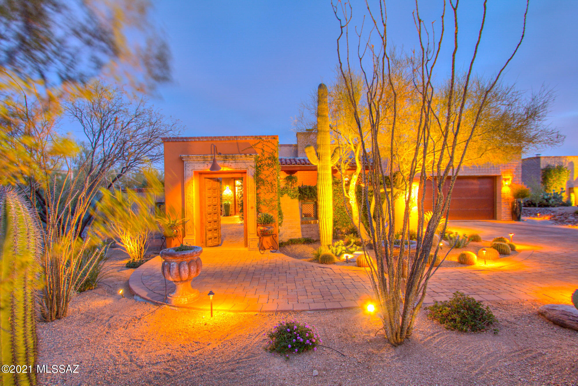 As you enter through the rustic courtyard gates you embrace the beauty and enchantment of the Sonoran desert in this authentic Mud Adobe home. Designed by James Gray of Stellar Gray Fine Homes, no detail was spared. Featured in Tucson Lifestyle this stunning open concept floor plan welcomes you into timeless luxury. Showcasing plank and beam ceilings, inlaid mosaic artwork, concrete floors, exposed and plastered Adobe walls, multiple fireplaces, knotty Alder cabinetry, slab granite and Viking appliances. Custom iron and glass doors lead you into an outdoor oasis. Sit back and relax on your deep covered patio while enjoying captivating Catalina Mountain, natural desert and city light views. Enjoy the refreshing solar heated pool on cool desert nights. With a new HVAC system, salt water pool equipment including Bluetooth Pentair technology, commercial grade irrigation system, and Bluetooth controlled landscape lighting all installed within the last year. The Tesla charging station in the garage is the finishing touch that makes this home truly turn key. An outstanding home that captures the Tucson luxury lifestyle that has been calling you.