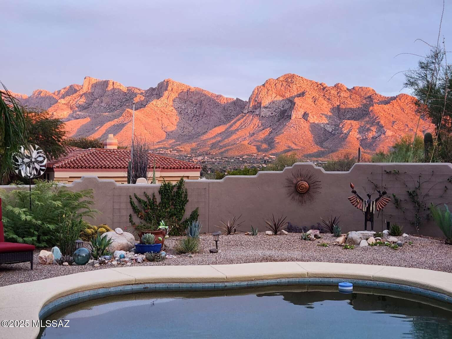 Gorgeous views of Pusch Ridge in highly desirable Canada Hills Estates! This is a 4 bedroom, 2 1/2 bathroom with office. The home has a split floor plan, all on one level with long flat driveway in a gated community in the heart of Oro Valley. The views from the living room and primary bedroom are amazing but are even more spectacular from the covered patio and pool area. The home has Saltillo tile floors throughout most of the living areas, Viga logs and rustic knotty alder cabinetry and interior doors. A complete remodel has been done over the past few years; bathrooms, kitchen, granite, lighting, HVAC, heating, pool area, outdoor fireplace, built-in BBQ and concrete counter. A complete listing of all amenities is available. This home is ready for you to move into!