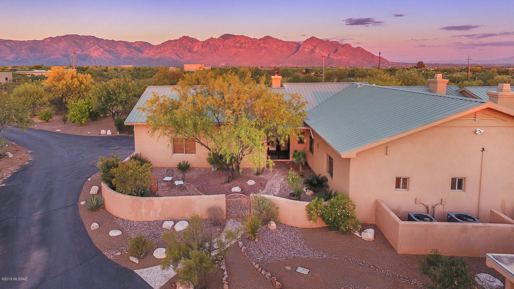 Spectacular 5BR/5BA (3,810 sq ft) private estate on 3.3 acres with east facing back yard and stunning mountain views! No HOA. 6 car garage +2 carports & plenty of work/storage space. Enter through a gated entrance & find a private home with an open floor plan perfect for indoor & outdoor living. Large gourmet kitchen with dual islands, granite counter-tops & stainless appliances. Great room with fireplace opens to kitchen. Extended Master suite hosts a fireplace, wine fridge & luxury bath. Private guest wing with family room & fire place. 2,500 Sqft of covered patios with full outdoor kitchen. Pebble-tec pool w/ waterfall & pool house. Observation deck with breathtaking views! RV pad with 50 watt electric.  Surround sound throughout. Leased solar for low electric bill. A must see!