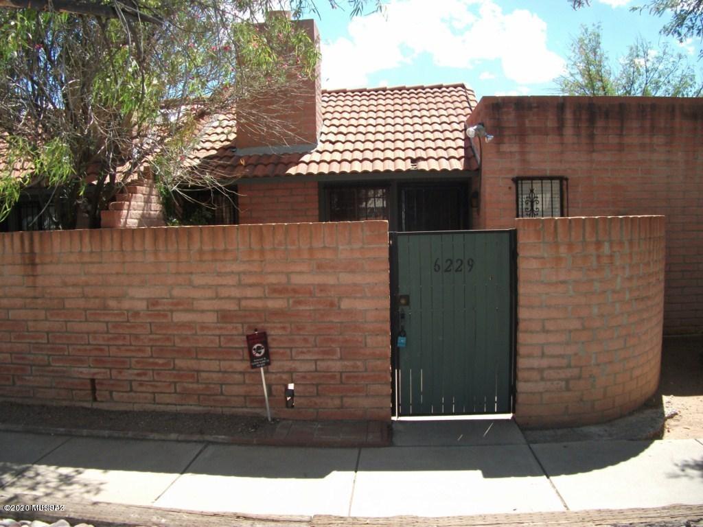 Furthest NE end unit past community pool. Cozy and comfortable! All saltillo tile flooring throughout. Slump block floor to ceiling fireplace in the living/dining center enhanced by vaulted ceilings. Galley kitchen has snack bar. 2 bedrooms and 2 full baths. Quaint patio.  Roof repairs and new coating just completed.  2 year warranty.
