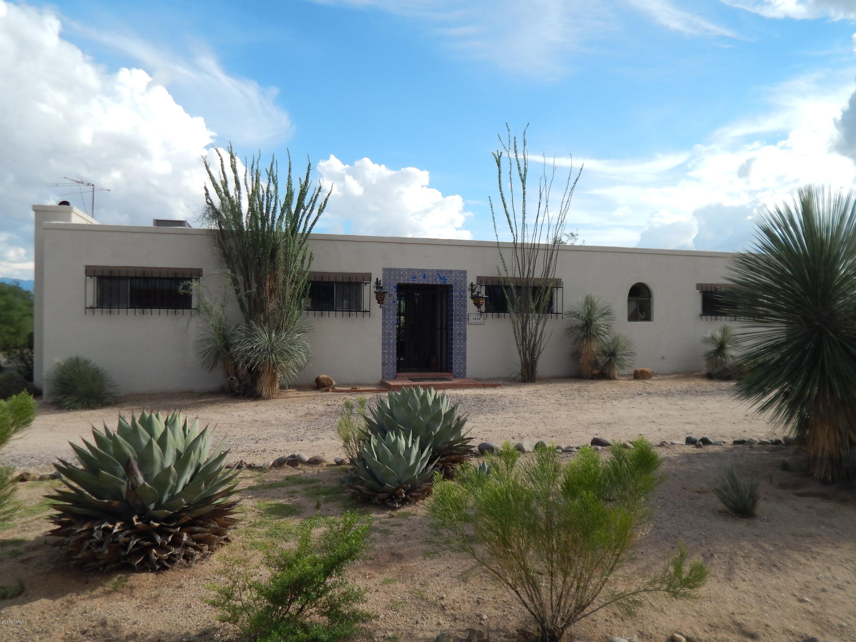 Only 20.3 miles to Tucson International Airport! Scraped wood beam ceilings, fireplaces and hand carved doors make this Hacienda your home. Custom built by Elizabeth ''Betty'' Hazen, with plenty of charm, this large  and private lot offers endless opportunities. Acre lot with natural desert landscaping.
No HOA, NO GVR, NO AGE RESTRICTION.
Sparkling pool and spa for relaxation and entertainment. There is no other home on the market today with the magic this home offers.
Newer Dual zone h/vac.