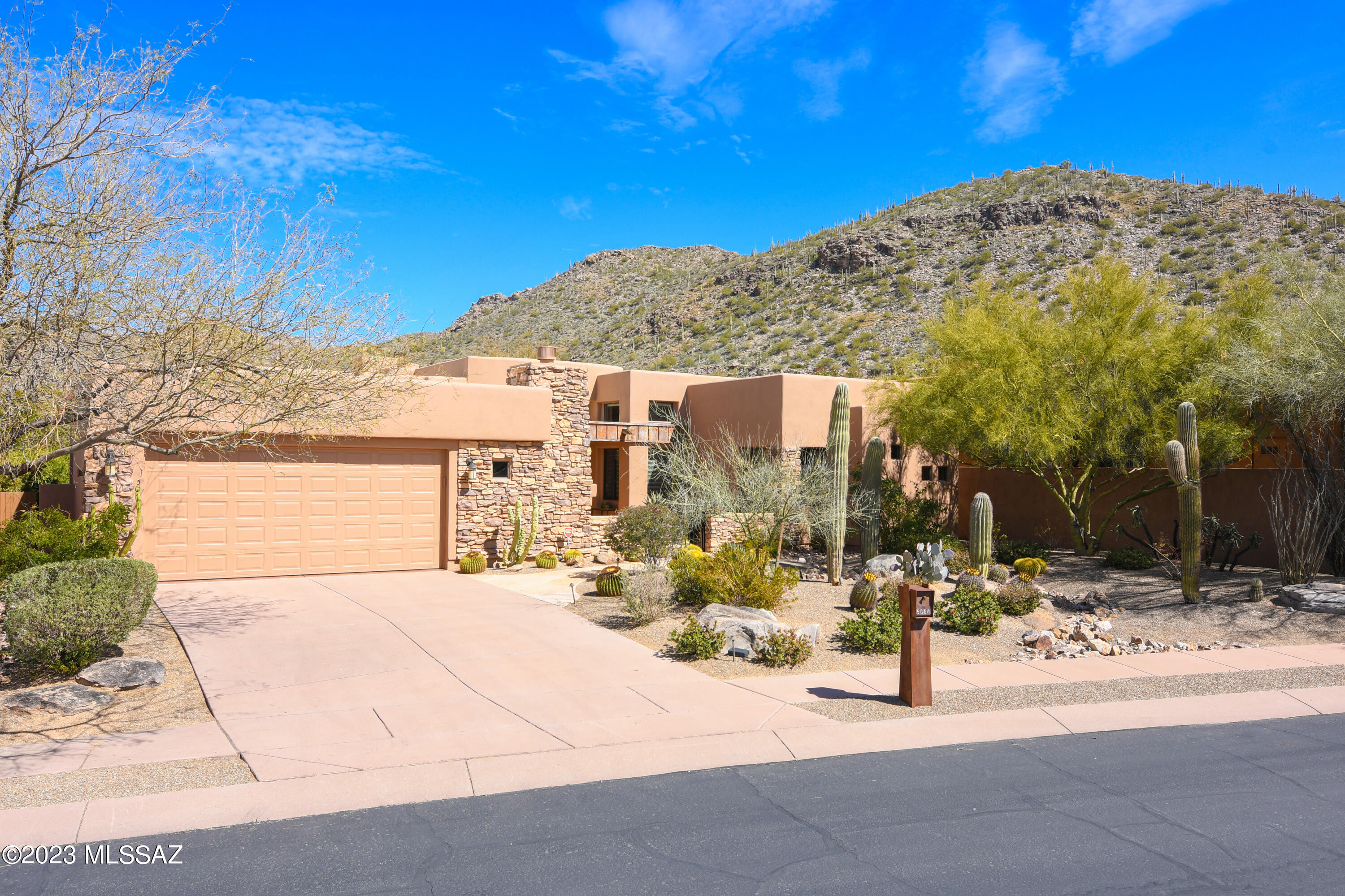 Stunning Golf Villa in Solana, a Gated small enclave of semi-custom homes tucked in against the Gallery golf course & Tortolita mountains. Originally a model home & loaded with upgrades. Great room with gorgeous stone floors, wood-like porcelain tile in bedrooms, no carpet, wood plank & beam ceilings, three gas fireplaces, 8'alder wood doors, exterior stone work with private front courtyard. Kitchen with hickory cabinets, s/s appliances, new hardware, granite counters & 5 burner gas cooktop. Private backyard with flagstone, huge covered patio area, built in BBQ, privacy & gorgeous mountain views. Large primary with built-in cabinetry & direct access to patio. Ensuite bath includes soaking tub, separate shower with custom glass surround & dual sinks. Guest room w/ensuite bath.  Must See!