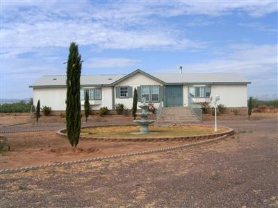 MANUFACTURED HOME WAS SET ON ONE ACRE BUT THE PRICE INCLUDES 2+ FENCED ACRES.TREES, BASKETBALL COURT, WATERFOUNTAIN, AND FULL SIZE COVERED PATIO; HOME ABOVE GROUND ABOUT 4FT, BEAUTIFUL MOUNTAIN VIEWS. 2250 SQUARE FEET, 4 BEDROOMS, GARDENTUB  & SHOWER, FIREPLACE, GOURMET KITCHEN, WET BAR, FORMAL DINNING ROOM, CEILING FANS, DOUBLE PANE WINDOWS, CIRCULATE DRIVEWAY. THERE ARE TWO LEGAL DESCRIPTIONS, TWO ADDRESSES, AND TWO TAX CODES TO BE COMBINED IF REQUIRED BY LENDER.OWNER AGENT DISCLOSURE REQUIRED. THIS IS A GREAT DEAL ( SELLER IS WILLING TO DO A SELLER CARRY BACK WITH $60,000 DOWN AND 8% APR)