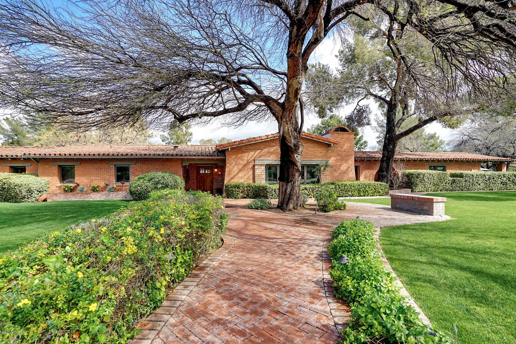 Designed by Tucson's most famous architect Josias Joesler, this 1951  Tucson Country Club Estate is a one of a kind. Situated on the 10th fairway, this 5000+ square foot split bedroom home provides unobstructed views of the Catalinas and the golf course. With 6 bedrooms and 4 bathroom in the main house there is plenty of room for the entire family. There is a bonus room that can be used as a guest facility, weight room,  or yoga room. Kids will delight in the lighted basketball court. This is one of the best lots in Tucson Country Club with beautiful, mature landscaping, and inviting lawn. A rare find with high ceilings, weeping mortar roof tiles, lots of light, and manicured lawns with reclaimed water. There is an additional two car garage. Historic, beautiful, and unique. Welcome Home