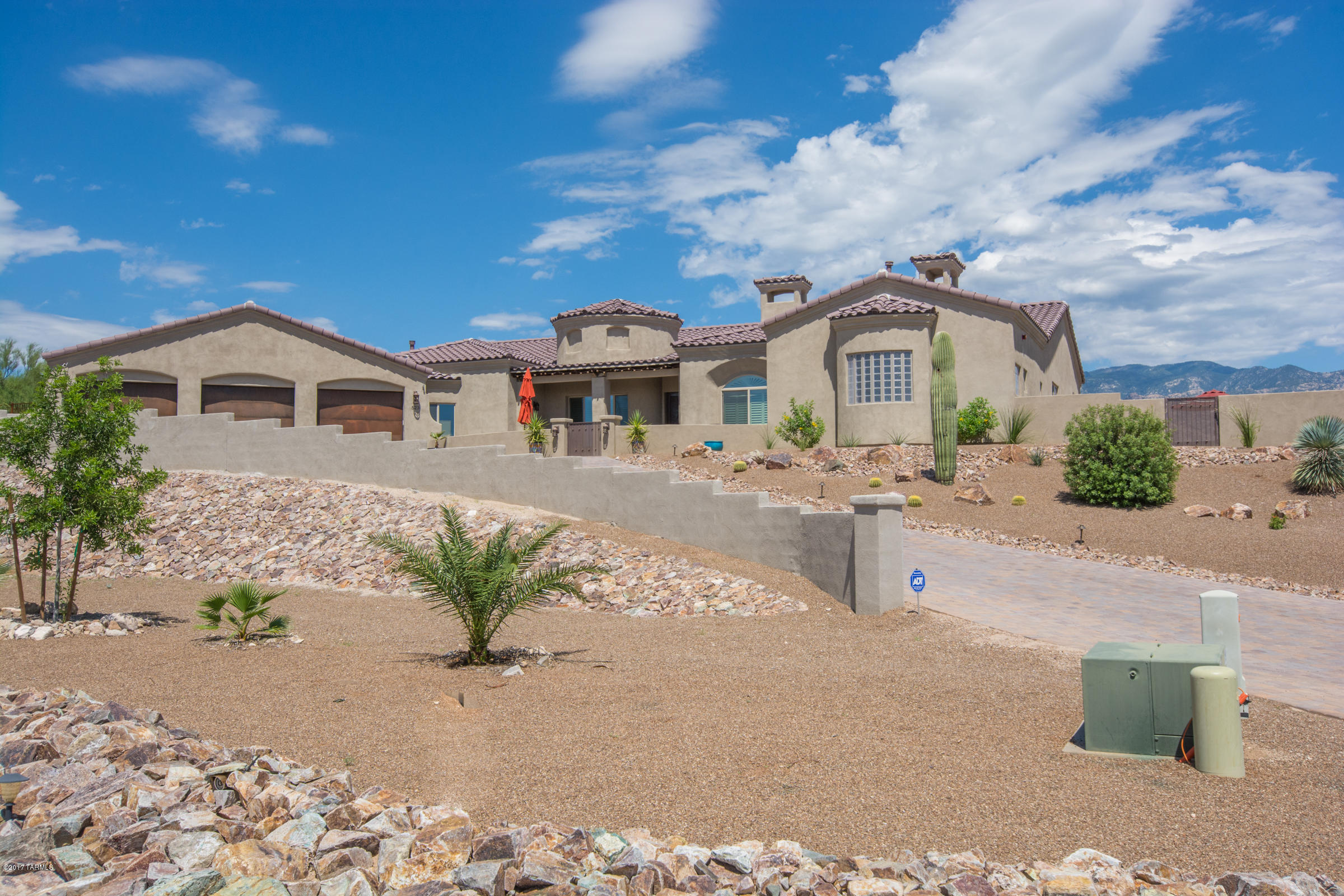 A DREAM HOME FOR SOMEONE WHO WANTS A CUSTOM HOME ON A HILLTOP WITH NO HOA RESTRICTIONS. OK TO PARK A BOAT OR RV ON THE WEST SIDE OF THIS HILLTOP BEAUTY. SOMBRA BUILT THIS BEAUTIFUL CASA FEATURING, 4 HUGE BEDROOMS, A MASTER SUITE WITH A GAS FIREPLACE PICTURESQUE WINDOWS THROUGHOUT FOR UNOBSTRUCTED VIEWS OF THE PUSCH RIDGE MOUNTAINS AND SUNSETS GALORE! WALK INTO THIS LUXURY HOME AND FEEL THE WARMTH AND SPACIOUSNESS THIS HOME HAS TO OFFER. SITTING HIGH ON OVER AN ACRE LOT WITH TREES, SHRUBS, FRUIT TREES AND A PEBBLE SHEEN SALT WATER POOL & SPA. HOME IS 2 1/2 YEARS NEW. THIS IS AN INCREDIBLE OPPORTUNITY TO HAVE A LUXURY HOME IN ORO VALLEY WITH NO HOA. A GOURMET KITCHEN WITH A HUGE BREAKFAST BAR, ISLAND AND A SEPARATE WET BAR. ALDERWOOD THROUGHOUT AND TRAVERTINE FLOORING. OUTSTANDING FLOOR PLAN
