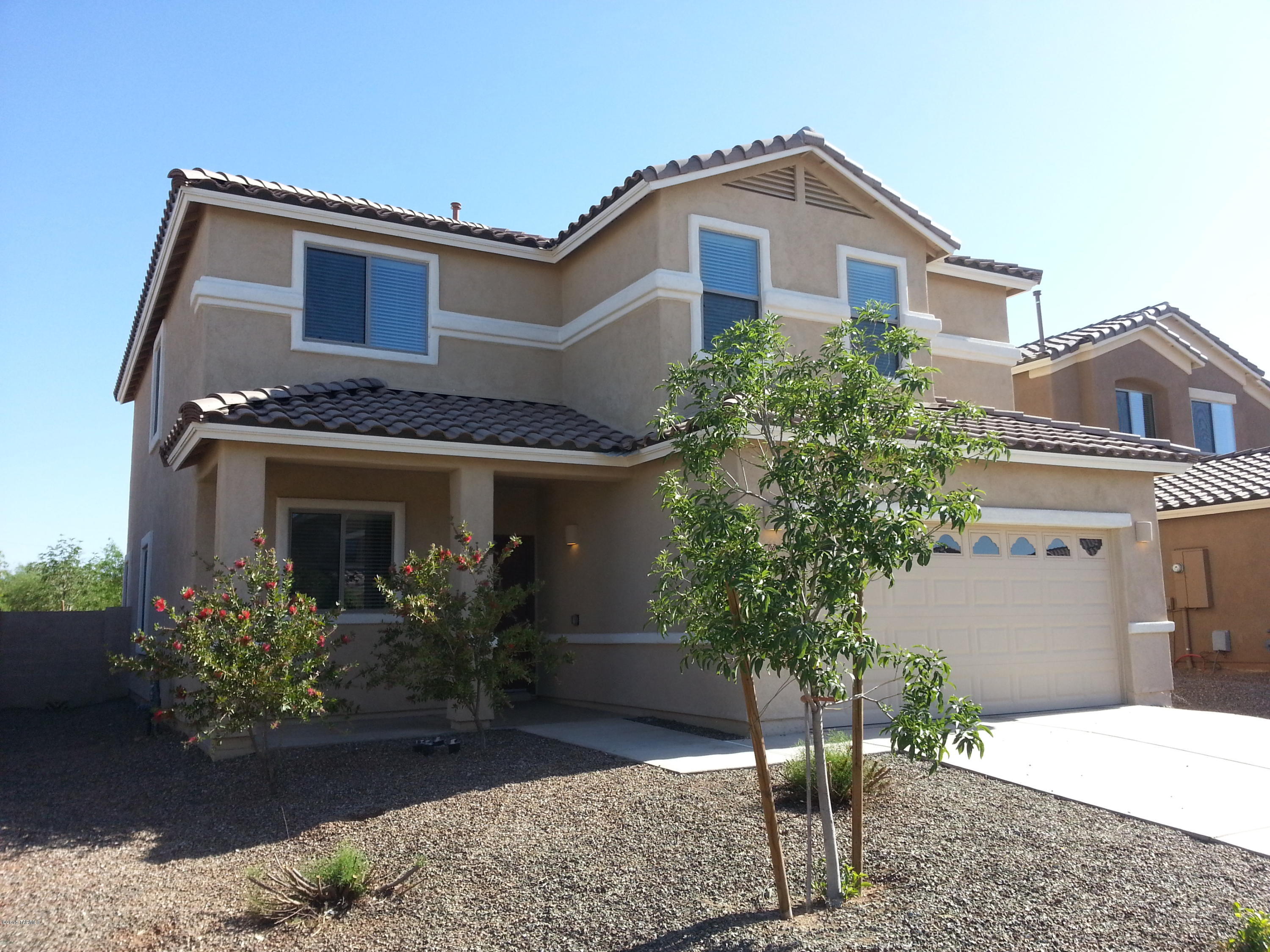 Absolutely a beautiful 4 bedroom, 2.5 bath house with a 2car garage and fenced GRASSY yard in sought after Rancho Sahuarita! 
 House is located on quiet cul de sac with no rear neighbors. Spectacular floor plan with soaring ceilings and open views. 
 All rooms are large with generous closets. 
 Ceramic tile in kitchen, downstairs hallway, laundry room and all baths; carpeting in formal living room, dining area and all bedrooms. 
 Window coverings and lighted ceiling fans throughout. 
 Gourmet kitchen has beautiful granite counter tops, tons of custom designed extra tall height cabinets and ALL NEW stainless steel appliances. 
 Awesome Master bedroom & bath is large with separate shower and garden soaking tub--huge master closet! 
 Upstairs loft is wired for surround sound and makes