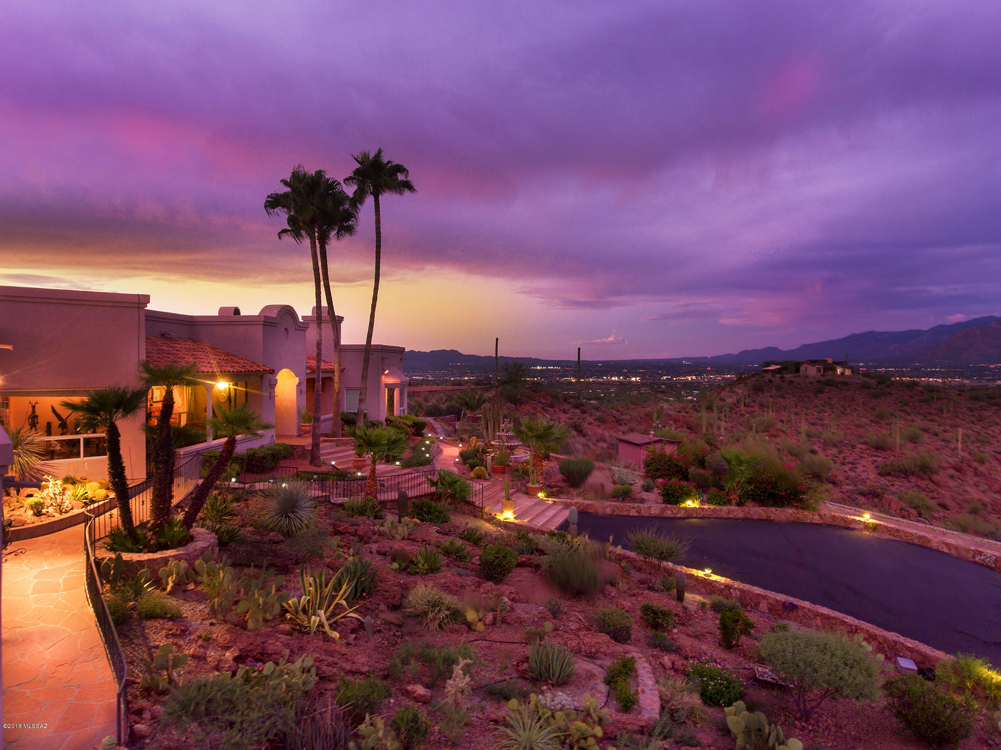 Spectacular Mountain Top Estate on 20 Saguaro Studded Acres with 360 Degrees of Some of the Most Breathtaking Views You'll Find in All of Tucson! Drive Through the Gate and Up the Winding Paved Drive Through Magnificent Boulder Fields and Saguaro Forests to This Captivating Custom Home Seemingly on the Top of the World! Open the Doors to the Spacious and Bright Floor Plan with Dramatic High Ceilings, 3 Fireplaces, and Amazing Views from Every Window! You'll Find This a Fabulous Home for Entertaining on Multiple Ridgetop Patios and a Huge Patio with Fireplace Overlooking the Sparkling Pool and Spa! Property Consists of 3 Parcels with Excellent Potential  for Future Development! Wonderful Solitude in a Stunningly Beautiful Setting!