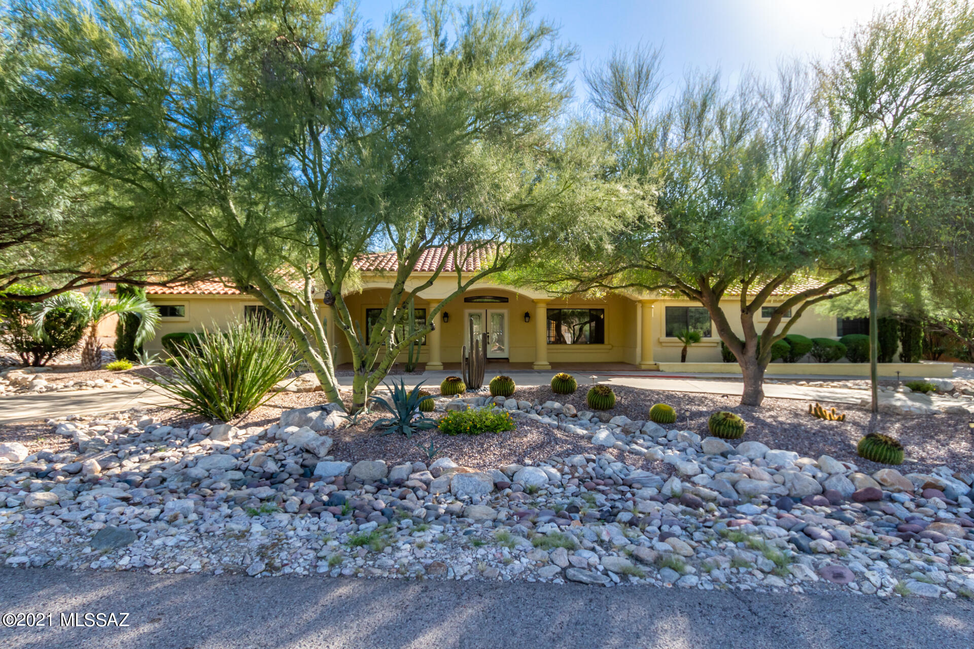 Luxurious home in the foothills with spacious living areas and bedrooms.  This split bedroom floorplan has two master suites with large walk-ins.  On the other end of the house is a third large bedroom and bath perfect for guests.  High ceilings in the great room make it ideal for entertaining around the fireplace or enjoy the beautiful Tucson evenings with your guests from the extended patios in the back.  A large built-in within the office contains desks, organizers, and filing cabinets making for a fully outfitted workspace. Access to district 16 schools make this location perfect for all families.