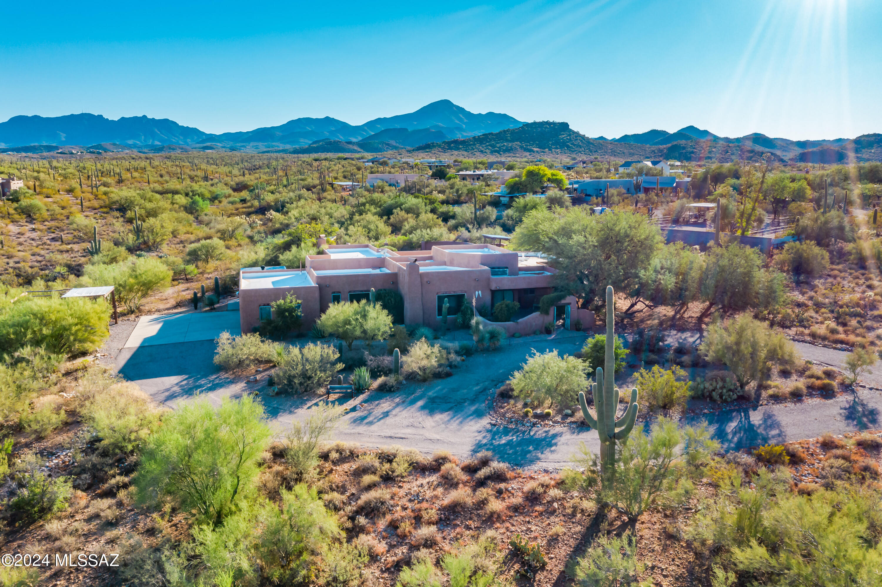 Gorgeous custom Southwestern home, with breathtaking city and mountain views, and entrancing sights of Saguaro National Monument from the backyard oasis. The private desert retreat features backyard that's an entertainer's dream, with large covered patio, pool/spa, fireplace and VIEWS!. The spacious home includes living & family rooms, den and office. Primary suite is owner's perfect escape with fireplace and lux bath for ultimate relaxation. Enjoy the rustic charm & luxury of wood-beamed ceilings with saguaro ribs, Saltillo tile and natural stone flooring. Large kitchen is flooded with natural light, lots of windows, showcases the picturesque views of the desert & monument. Charming courtyard adds to the allure of the home, and is the perfect entrance to private, tranquil living!!