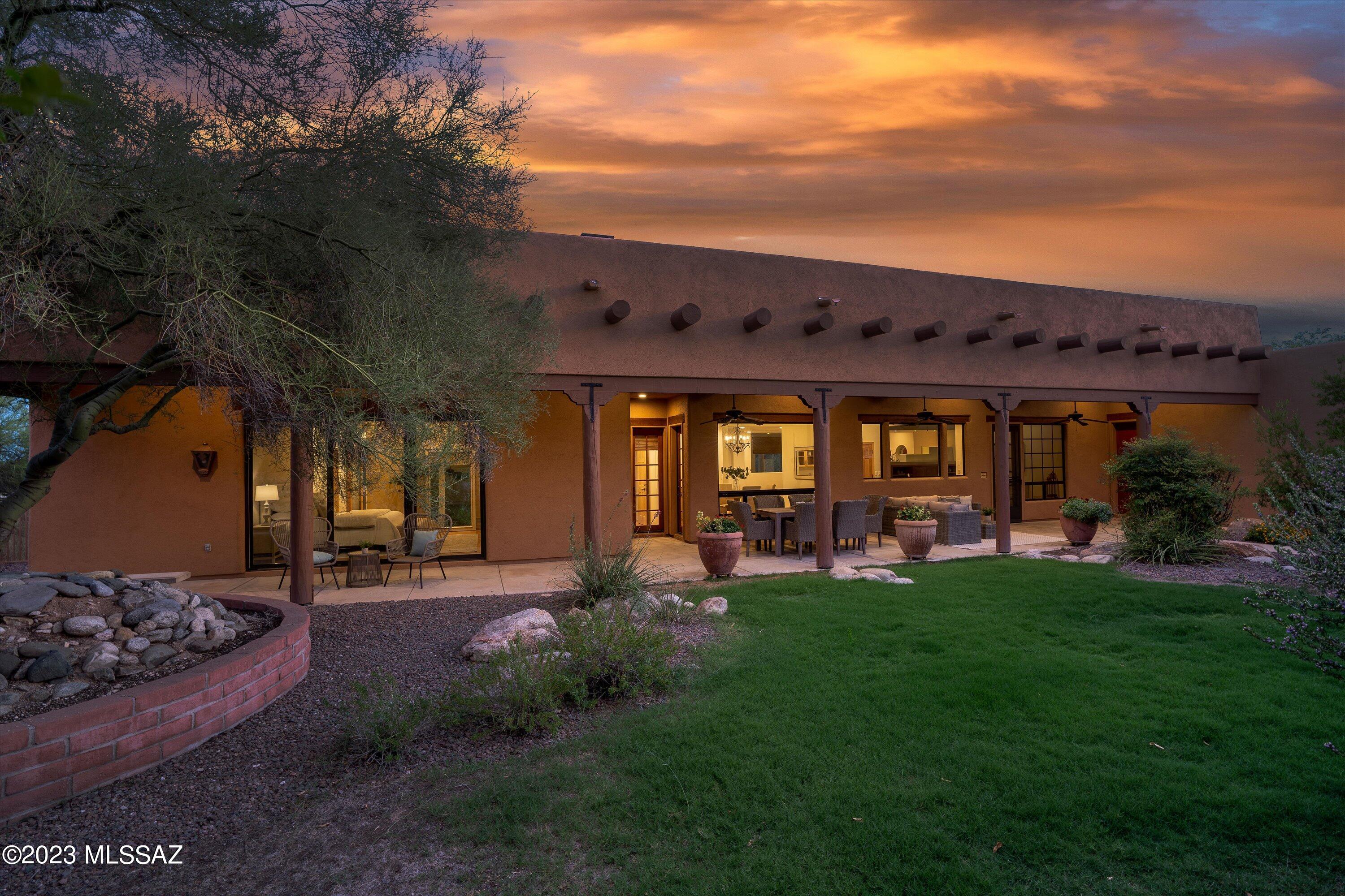 Fabulous Santa Fe Style home situated at the end of a cul-de-sac with panoramic views! Designed & built by architect John Archer 4bd/2.5ba PLUS gym/office with exterior door. The front doors are massive hand carved wood doors welcoming you in. The living room & family room both have 13' high ceilings w/Viga beams & latillas & each with a masonry Beehive Fireplace. Beautiful Mexican Saltillo floors & natural wood doors complete the charm. The primary suite has wood floors, masonry fireplace, 13' ceilings, dual closets with separate vanities, & bonus room. Open concept kitchen features massive windows bringing the backyard & views in! Granite countertops & walk-in butler pantry. The home offers plenty of closets & storage, 3 car garage. One seller is licensed real estate agent in AZ Overlooking acres of common area & Tanque Verde Creek this home offers city light views, distant golf course views and Catalina Mountain views. Close to TMC, Basis and the Gregory schools.