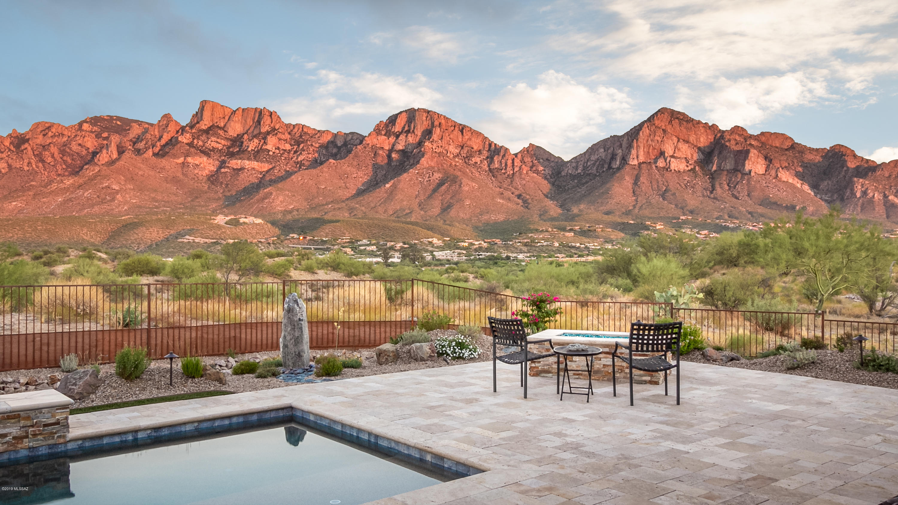 This Gorgeous home is situated on .65 Acres with Stunning Unobstructed Catalina Mountain Views in the heart of Oro Valley. One of the best lots in the neighborhood. Large Open Floorplan with Gourmet Kitchen, Backsplash, Satin Finish Granite Island, Gas Stove and Butler's Pantry. Over sized Master Retreat with extra Room. Relax in this beautiful backyard with extended Covered Patio, Pool and Spa, Putting Green and Glass Firepit. The backyard was featured in Tucson Lifestyle Magazine July 2019 issue. 3 Car Garage and Driveway has Extended Pavers. This Home has it all!