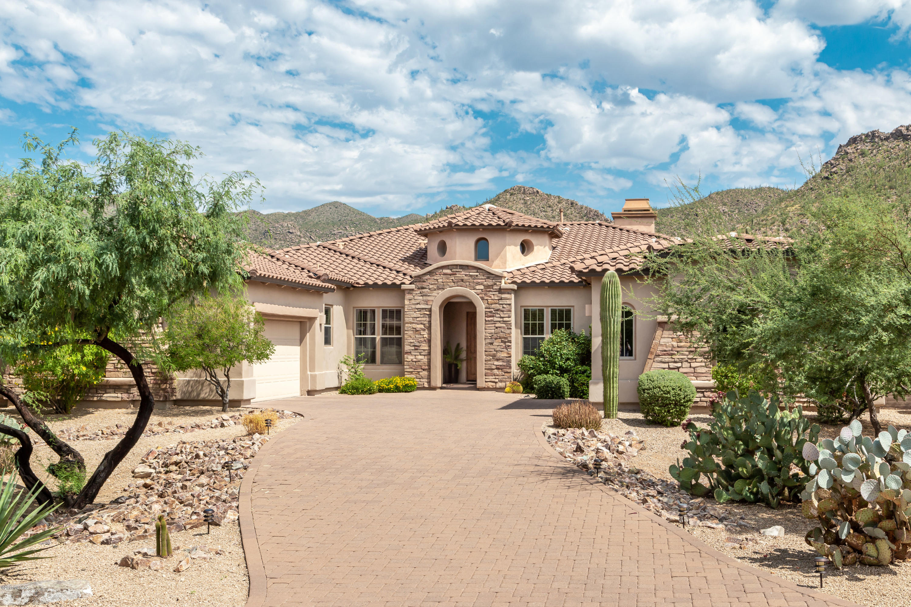 Highly upgraded Toll Brothers Home in gated Solana at Dove Mountain backs to Gallery North Course 17th Hole boasting Tortolita views. Walk to Clubhouse or entertain outdoors by the pool, spa and fireplace. This exquisite home features 3BR/3 and a half baths.  Office and 2+1 garage bays. Tuscan inspired design opens to a Grand Foyer entry into the Elegant Great Room features  dual sitting areas, full Bar, faux stacked stone fireplace, circular Dining Room, and state-of-the-art Kitchen w/Breakfast Nook & Bar. Extended Master Suite w/sitting area hosts a faux stacked stone fireplace, wet bar, dual walk-in closets, huge master bath and more. Beautiful home and a must see !!!