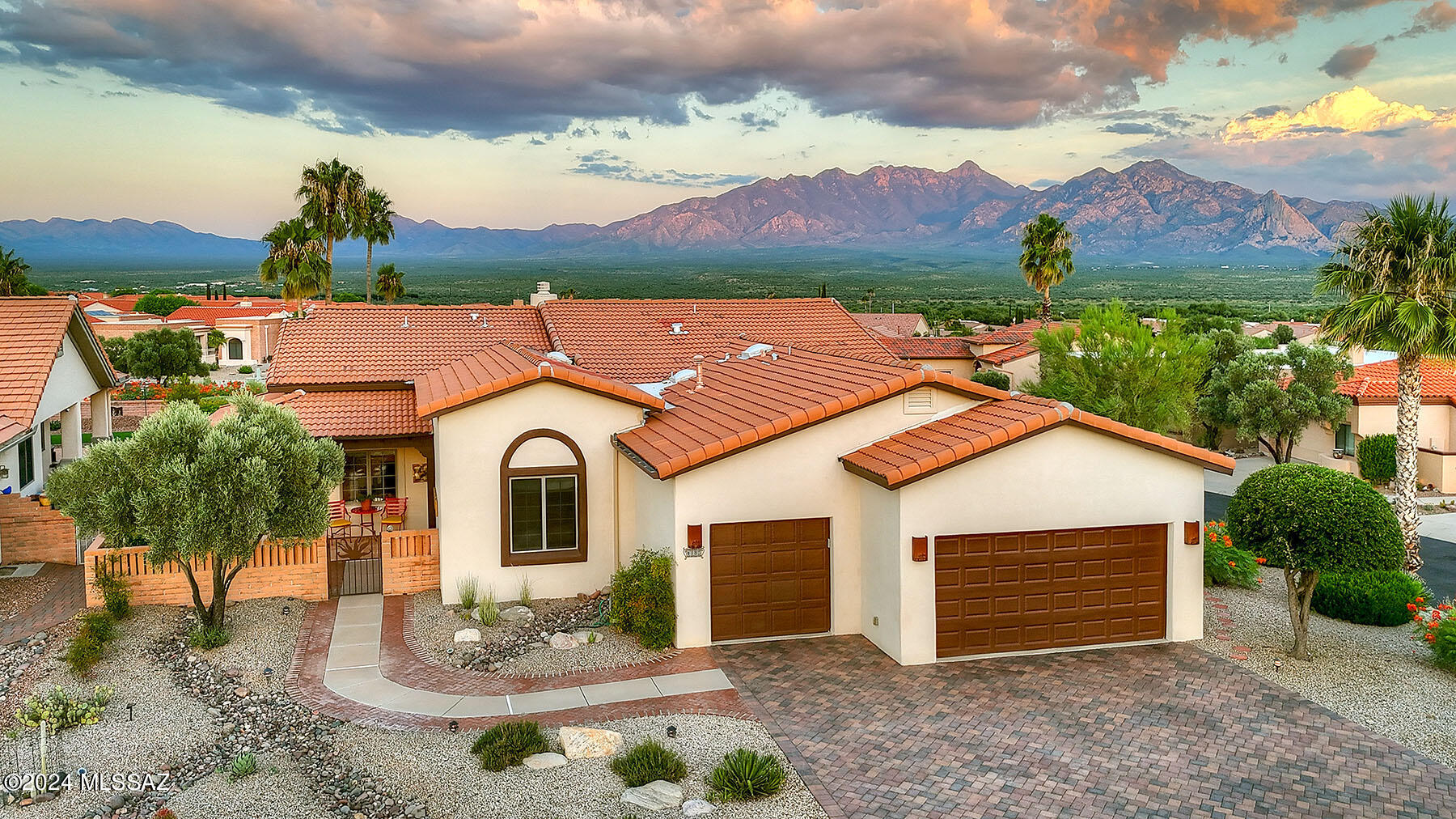 For the homeowner that values VIEWS, privacy, and beautiful outdoor living spaces, there is no better choice than this highly customized DORN home in San Ignacio Heights! Truly the jewel of the neighborhood,  this incredible home is surrounded by mountain VIEWS that are sure to take your breath away!  This home has also been SIGNIFICANTLY enhanced by current owner, se be sure to ask for list of upgrades.  The red bricked driveway elevates the curb appeal of the home and  leads you into the charming  front courtyard and entry.  Stepping inside, soaring ceilings have been raised to 15 feet in the great room to add to the spacious volume and elegance of the home.  Guests will be immediately entranced with the mountain views coming in through large wooden framed sliders!  Stepping outside, the views are panoramic and are the backdrop for the magnificent, meticulously manicured back yard. Agurgling fountain adds ambience to the outdoor living space and the patio features several options for seating and entertaining. Back inside, the great room is anchored with a floor to ceiling beehive fireplace. The dining room space is beautifully defined yet still open to the living area. The kitchen will immediately   impress with a gleaming white quartz island at its center.  A breakfast nook is perfect for more quiet mornings and has french doors leading out to the BBQ patio. The formal den is adjacent to the living area but can be closed off with french doors when guests arrive.  Your primary suite is luxurious with mountain views framed by large windows and private access to the spectacular patio.  Separate vanities, a soaking tub and a tiled, walk in shower add to the spa-like feel of the suite.  Guests will feel pampered with their own en-suite.  An extended three car garage will accommodate larger vehicles or motorized toys. There is nothing about this exceptional home that does not exude elegance and taste. The location and views simply make it "PERFECT".