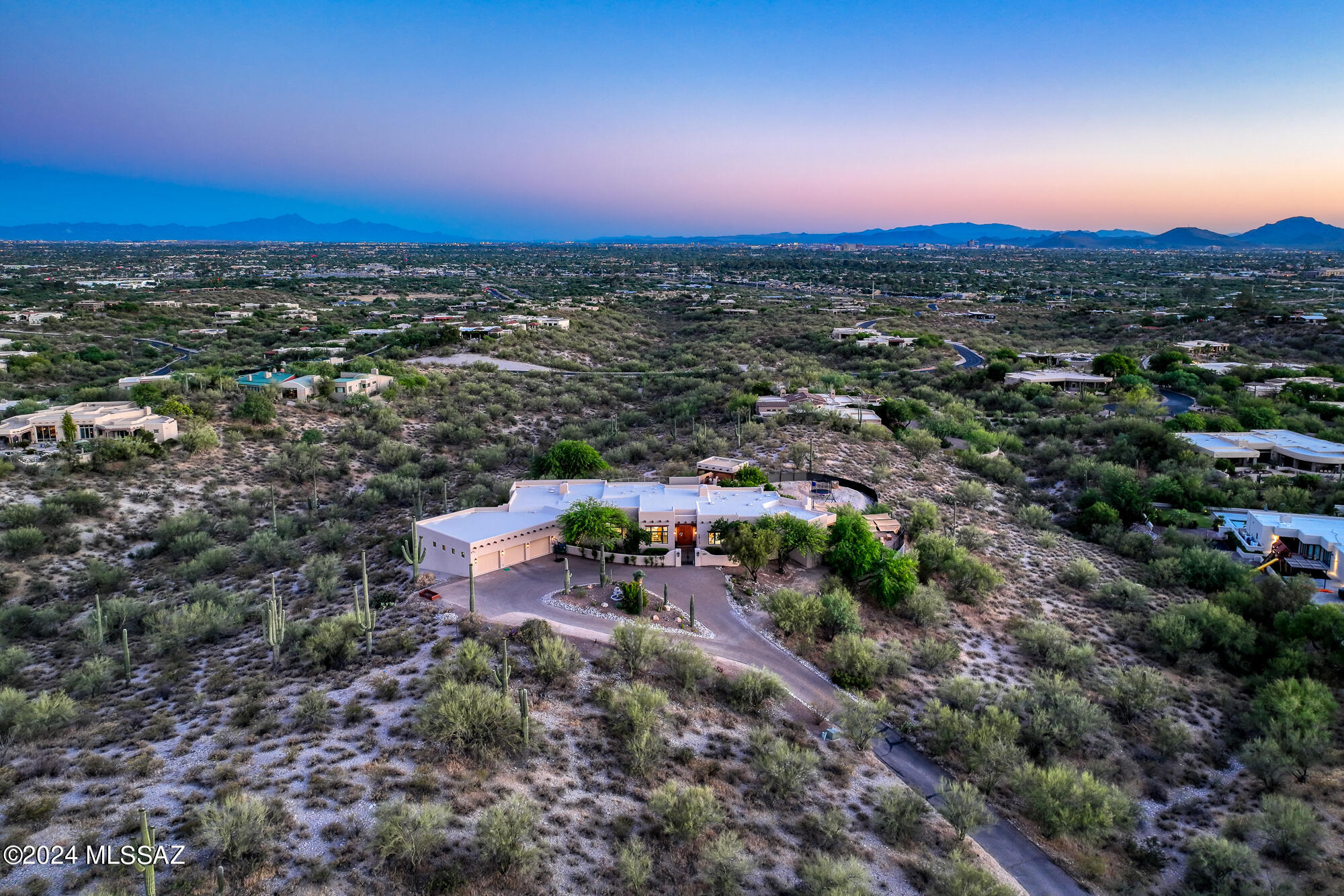 Beautiful Southwestern home, sitting clandestinely on 4.13 acres with breathtaking views and extensive privacy. Built by award winning custom home builder Mike Wachs, this 4,937 Sq Ft, 4 bedrooms & 4 bathrooms, split floor plan offers generous space yet private comfort & luxury. Located in the gated 9 home community of La Puerta, in the heart of the Catalina Foothills, the panoramic Catalina Mountain views are prominently featured with the city lights of Tucson's valley set as your backdrop. Resplendent wood floors are featured throughout the common spaces and spacious primary bedroom. The backyard is surrounded by serene desert landscape & features resort-style amenities that provide perfect relaxation & entertainment options: Large turf area with pool, oversized ramada with expansive views of the city, built-in BBQ & dining space under the large, covered patio. Adjacent to the backyard on the south and southwest side of the property, sits a fenced in flex space that is ideal for gardening, playground, or desert oasis.

The primary suite is positioned with direct access to the backyard and private courtyard. A vast retreat with sitting area with gas fireplace and attached exercise or office space. The self-contained suite provides ultimate privacy and luxury, with spa-like ensuite primary bathroom that features two closets, dual vanity areas, a walk-in shower and jetted tub.

Just off the family room, two sizable guest bedrooms; one with an adjacent full bathroom that has direct access to the backyard and an additional large guest bedroom with ensuite, creating a private guest bedroom wing. The fourth bedroom has limitless options in addition to being a bedroom, as either a playroom, office, game room or den.

Large common area spaces with an abundance of natural light. Both the dining room & living room are sizable spaces that are perfect for entertainment. Adjacent to the kitchen, bar and family room is an additional space that could be utilized as a built-out bar, billiard room, or entertainment space. With multiple considerably sized common area spaces, the home provides a floorplan the enables inspiration and creative power.

The kitchen and family room are well thought out for both entertainment and intimate family gatherings. Just completely remodeled with brand new countertops, appliances and cabinets, a cook's kitchen with versatile space.

Phenomenal location, close proximity to La Encantada and Joesler Village, La Paloma Country Club and direct access to downtown. Countless details and high-end character throughout with a high level of maintenance. Oversized 3-car garage with additional storage and long private driveway.

Catalina Foothills, located in the Santa Catalina Mountains just north of Tucson, Arizona, is known for its stunning natural beauty and desirable living conditions. Here are several reasons why people choose to live in Catalina Foothills:

Scenic Views: The area offers breathtaking views of the Sonoran Desert, city lights, and the surrounding mountain ranges. Residents enjoy picturesque landscapes and sunsets.

Outdoor Recreation: Catalina Foothills provides easy access to outdoor activities such as hiking, biking, and bird watching in the Catalina State Park and Sabino Canyon Recreation Area.

Mild Climate: The region experiences a mild climate with warm temperatures during the winter months and cooler temperatures in the summer due to its higher elevation. This appeals to those who prefer a more temperate climate compared to the intense heat of the desert floor.

Upscale Living: Catalina Foothills is known for its upscale neighborhoods, luxurious homes, and a high standard of living. The area attracts professionals, retirees, and individuals seeking an affluent lifestyle.

Quality Schools: The area is home to reputable schools, making it attractive to families seeking quality education for their children.

Proximity to Amenities: Catalina Foothills is close to shopping centers, restaurants, and entertainment options. Residents can enjoy the convenience of urban amenities while living in a more serene environment.

Community Atmosphere: The community in Catalina Foothills often emphasizes a relaxed and friendly atmosphere. Many residents appreciate the sense of community and the opportunity to connect with like-minded individuals.

Health and Wellness: The region attracts individuals interested in a healthy and active lifestyle. The availability of outdoor activities and wellness-focused amenities contributes to a health-conscious community.

Overall, the Catalina Foothills offer a combination of natural beauty, outdoor activities, upscale living, and a strong sense of community, making it an appealing place for many individuals and families to call home.