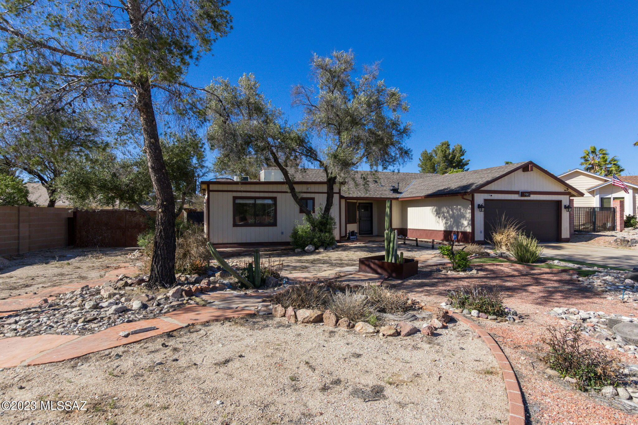 This stunning home is nestled away from the road on a quiet cul-de-sac on a large lot.  Once you step inside, you'll find a home that's been updated including a charming planked wall, recessed lighting accents, and wood plank tile flooring. The beautifully tiled bathrooms and kitchen are a testament to the quality of the upgrades and show off the home's modern design. With five bedrooms, this home has plenty of space for a growing family or entertaining guests. BONUS: The 5th bedroom, with its own exterior door and private bathroom, is the perfect space for guests to stay or to be used as a home office or as a multi-generational suite for a family member. The possibilities are endless with this gem. The backyard provides ample room for play and entertaining, complete with a covered cantina that's perfect for enjoying the warm Arizona weather year-round and a shed, with its own electrical, can be used for storage or as a workspace.  The newly erected retaining wall has provided an additional 12 feet of backyard space making this ready for you to create your own oasis.  The roof was replaced in 2020 and new HVAC. Don't miss out on the opportunity to make this incredible East side home your own. Hurry, it won't be available for long!