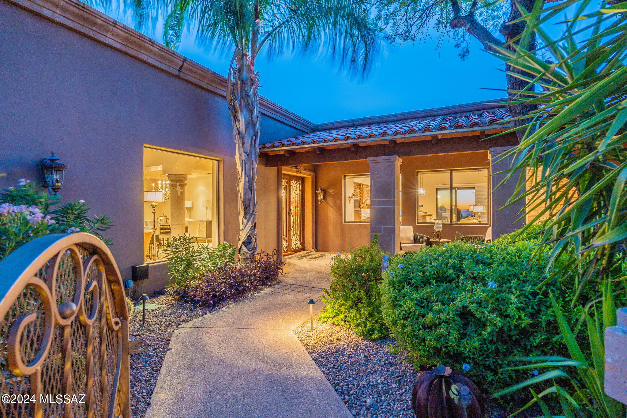 A masterpiece of modern elegance. This exquisite home boasts meticulous attention to detail, from the Cantera stone accents to the stunning hand-carved cabinetry. Enjoy expansive, light-filled living spaces that offer breathtaking 360-degree views. A chef's dream kitchen and a luxurious master suite with rich wood floors, a stacked stone fireplace, a large walk-in closet, and a spa-like master bath complete this exceptional property. Outdoor living at its finest. Relax on the expansive patio, complete with a built-in barbecue, travertine tile and a sparkling pool that offers stunning city light and mountain views.