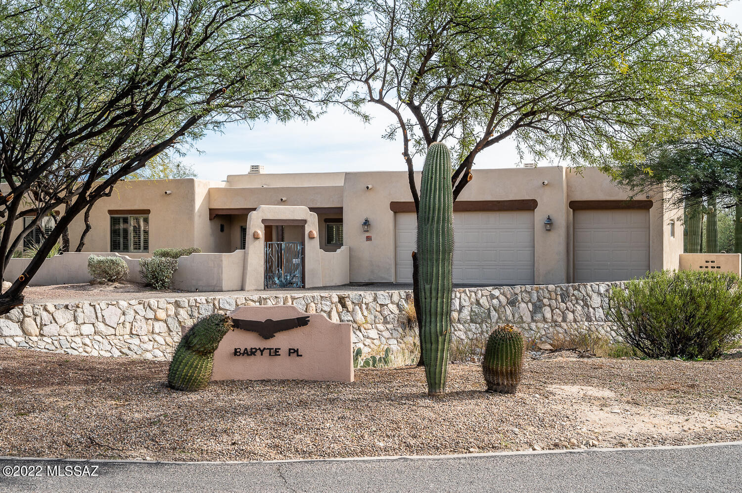 Santa Fe style home nestled in the Tanque Verde Valley with gorgeous Catalina Mountain views! Large open Great Room w/vigas, built-in buffet, Mexican-tiled wet bar, gas fireplace. Large Primary Bedroom w. gas fireplace, dual sink vanity, bath with jetted tub, separate shower, and new cedar wood closet.  Double oven in kitchen and a very large walk-in pantry! Guest Suite w. mini-kitchen, private bath, and access to back patio & spool. The home has beautiful tiling, woodwork, and southwest colors. Property is located on over an acre with many beautiful Saguaros. Close to AZ Nat'l golf course, schools, McDonald Park, & Tanque Verde shopping centers.