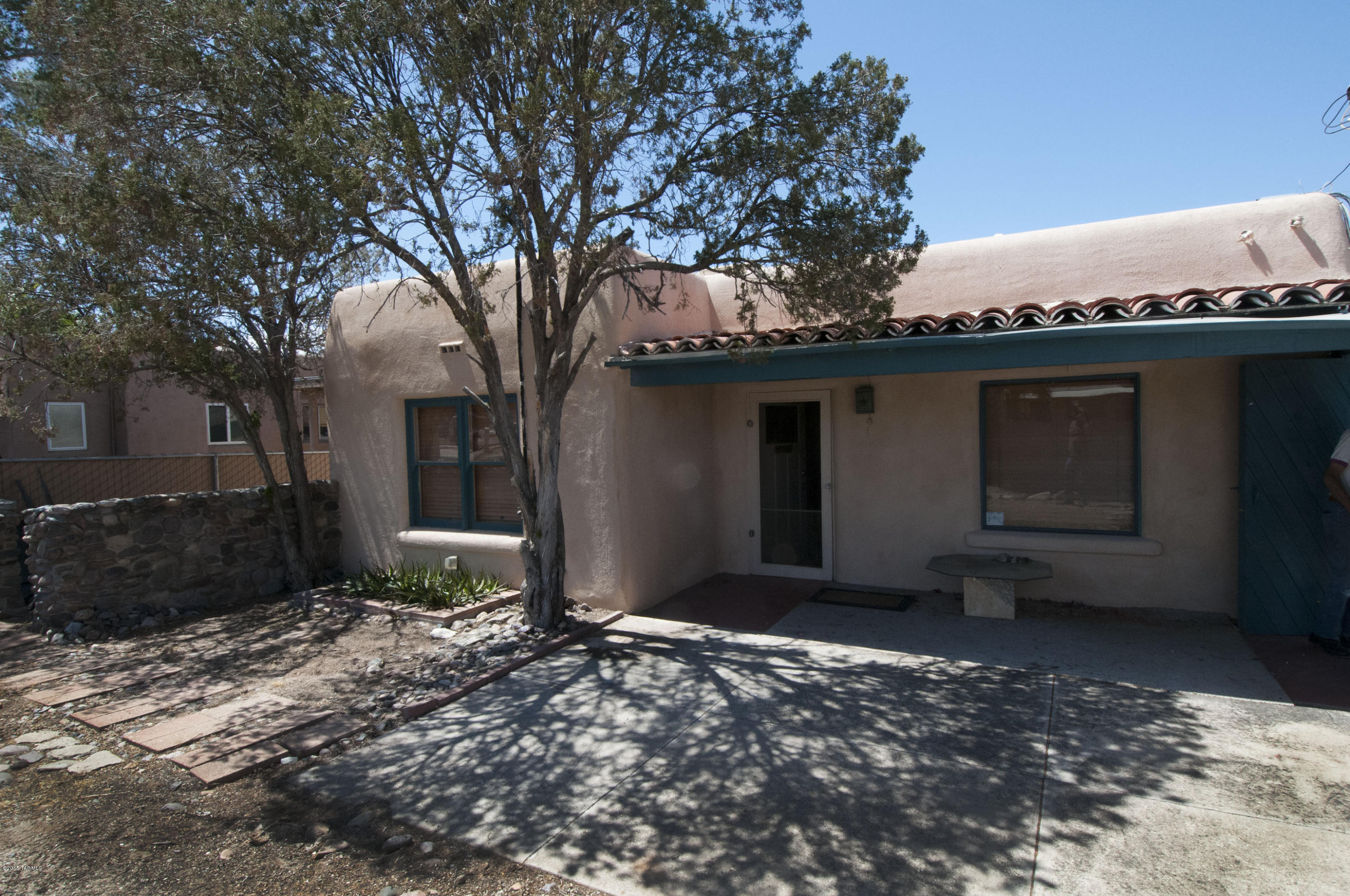 Convenient central location that is just minutes to U of A, restaurants, movies, UMC, and park! 3 bedrooms, 2 baths, private front walled stucco court yard with covered patio. Master bedroom has a large master bath, second bedroom off kitchen has French doors. Living room has a wood burning fireplace, and is spacious and open. Updated kitchen is large and bright. Wood and ceramic tile floors thru out. This home is well maintained. Backyard is private and big with a covered patio and storage room! 2 carport spaces. Spa to convey in ''as is'' cond. brand new hot water heater just installed May 2015, has warranty and service plan.