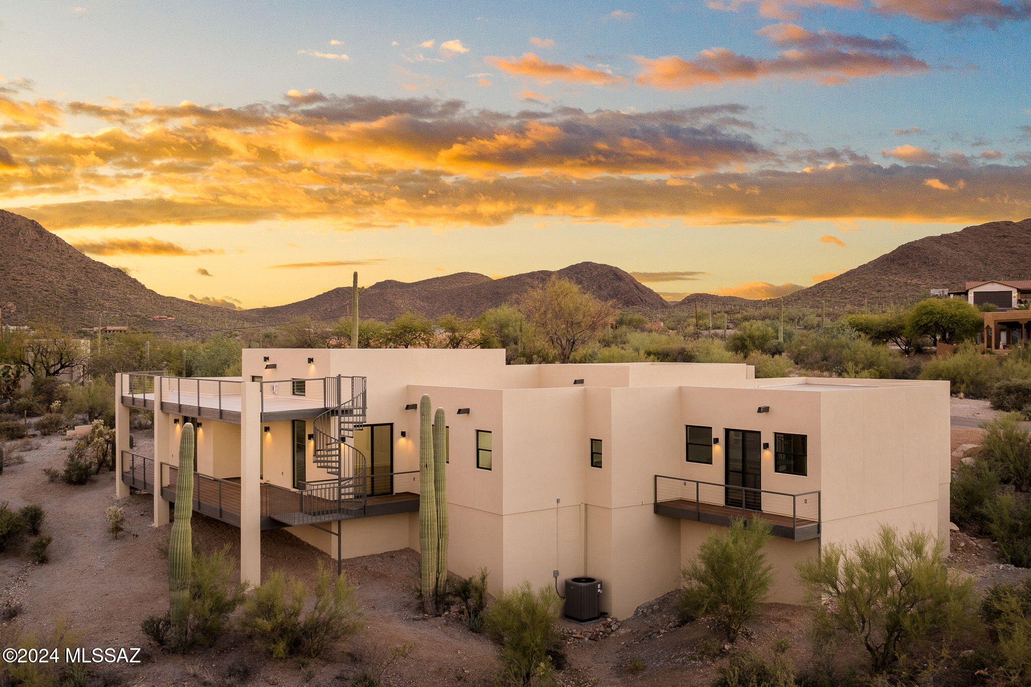 This contemporary, 
Architect/Structural Engineer, Design/Build New Construction is cradled in the Tucson Mountains at the mouth of Gates Pass. Easy scenic minutes to shopping, hospital, Pima College, Downtown & UofA; yet a world away embraced by lush, saguaro-studded desert. Hiking, biking trails nearby. Clean lines. Understated elegance.  BOSS floor plan.  Open, spacious.  No hallways. No interior steps. High ceilings. Tall windows. Large bedrooms. Roomy closets. Stained concrete floors in timeless rich tone. 
The chef's super-functional kitchen is FIRE!  Quartz tops, Bosch Appliances. Walk-in pantry. MAGNIF gather-all-around island.  The great room gas fireplace is LIT! The 5th bedroom is a LEGIT guest suite w/ wet bar and private balcony. Baths SWAGGER with Frenchy COOL VIBE. Primary bedroom has private access to the deck. Primary bath has a separate toilet room and ROCKS a moody-luscious roll-in shower, CHILL soaking tub and separate marble-topped vanities. Kohler toilets throughout. EVC outlet in three car garage. Rinnai tankless hot water heater. West half of acre lot has separate entrance around the corner and can serve as extra guest parking for many cars. Or for building a casita.  Separate sewer connection and other utilities located at the west boundary. Loads of potential here! Back yard is in its pristine, undisturbed, natural state but has lots of room for a pool if that floats your boat. Entertain and CHILLAX from two decks. BBQ stub on lower deck. Upper deck is perfect for evening gatherings as city views are optimized from this vantage point.
OWNER/AGENT