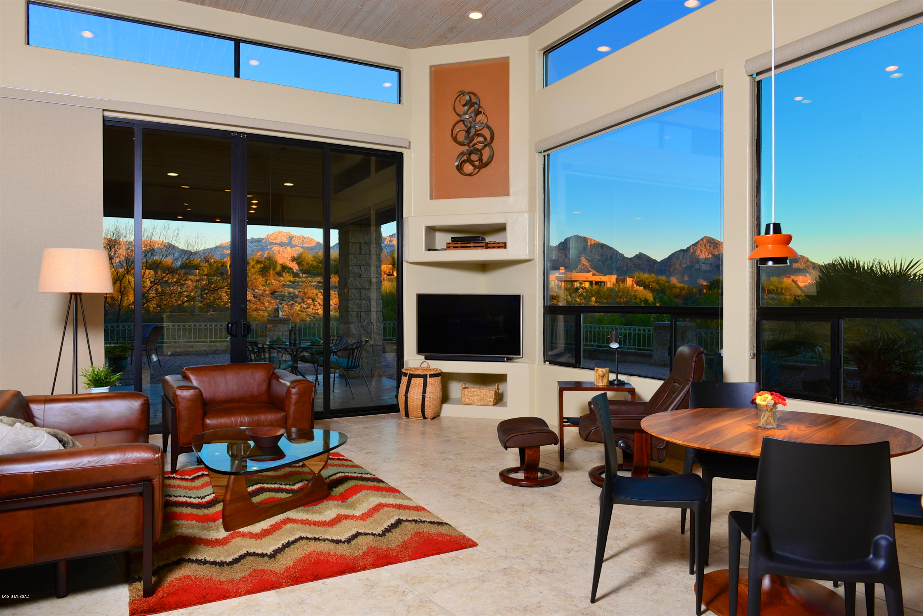 STUNNING CONTEMPORARY WITH PANORAMIC VIEWS! Perfectly situated on .58ac in Moonridge Estates, this home offers all the best for Arizona living. 3328sf of sophisticated upgrades, tasteful designer choices & accents throughout this flexible 4BR/3BA split plan. Floor-to-ceiling stone gas FP, custom paint, solid maple doors, stylish finishes in bathrooms, GIANT VIEWS from so many rooms that will take your breath away. Gourmet kitchen w/all Viking appliances, plus built-in wine cooler & walk-in pantry. 5-burner gas stove, subway backsplash, pendant lighting, maple cabinets and solid granite. Breakfast area and the upscale family room extend from the kitchen and beyond to the large inviting outdoor living area and those VIEWS. New landscape & irrig plus epoxied 3-car garage + much much more!!