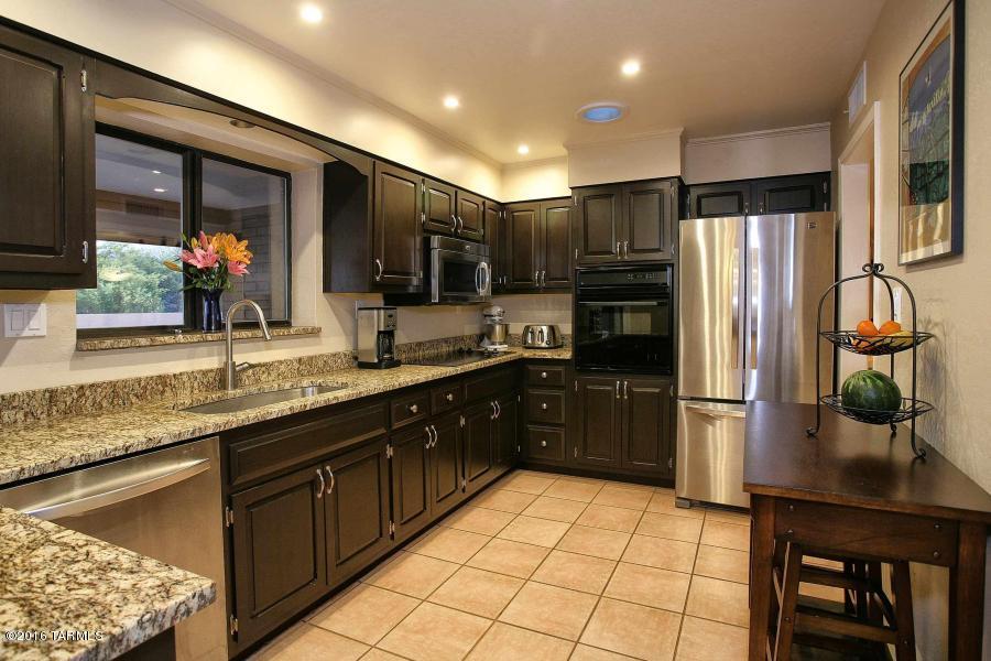 Gorgeous 4 bed/2 bath home nestled in the Tucson Mountain foothills. The property features 3.4 acres of land with stunning views, space for horses and an RV. Owner just built a detached 30x24 3-car garage with 110 electrical that can house 6 cars if lifts are used in addition to the 2-car attached garage. The home itself has two living areas, a formal dining room & eat in kitchen with granite counter tops, espresso cabinets and stainless steel appliances. Beautiful views of the back yard from the kitchen and large outdoor living space with separate ramada, built in fire place, sparkling pool and large grassy yard. Energy efficient brick home, 100% electric, dual pane windows, A/C and fully functional evaporative cooler. Plumbing in place for solar water heater if desired. Must see!