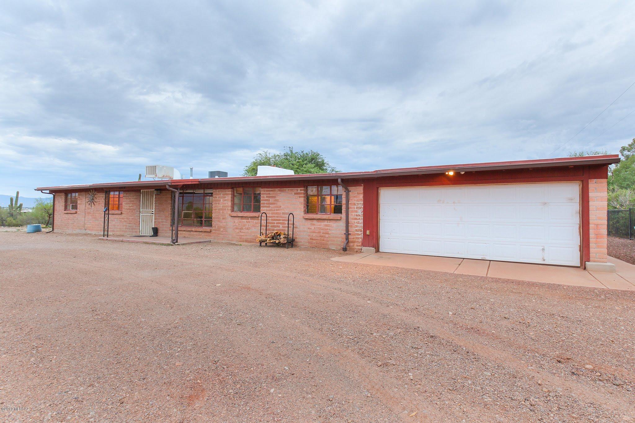 Life on a Ranch within minutes of modern convenience? It's all within reach with this original ranch home amidst 3.6 acres, horse facilities include horse stalls, corral, exercise machine, 2 tack rooms, access from North/ South end of property, enclosed private courtyard for the house. The house features 3bd/2ba, living room, AZ room, Rec/Den, Wine Room, very large laundry room and attached 2 car garage. The possibilities are endless, board horses, events, airbnb, or enjoy living the ranch life with tremendous city, mountain and sunset views unlike anywhere in the country. You are blessed to have mature trees near the home, saguaros all throughout the 3.6 acres. Convenience to amenities and I-10 within minutes less than 10 minutes. A little of Az History. View it for yourself.