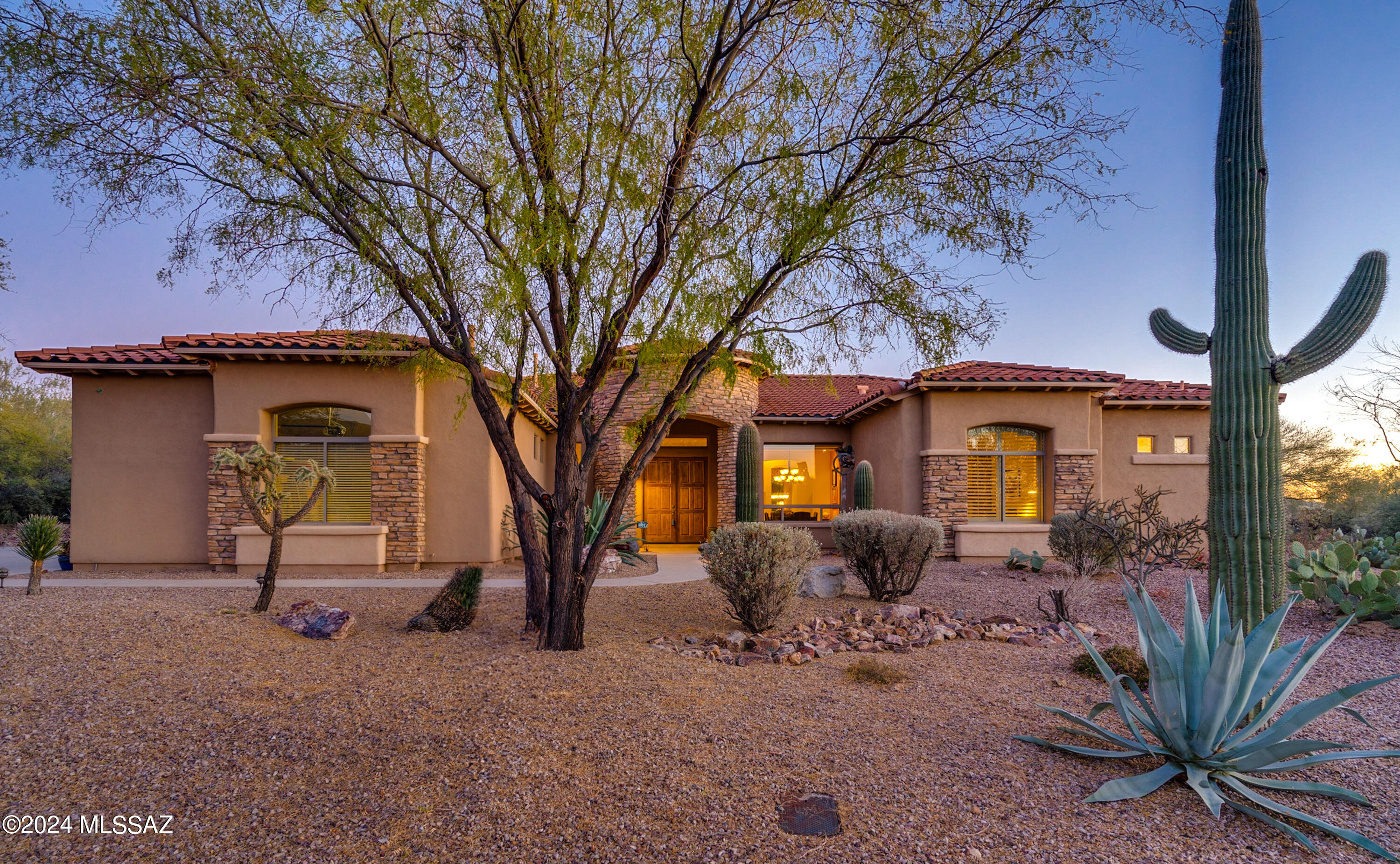 SPRING SPECIAL! (SELLER WILL COUNTER OR ACCEPT OFFERS FROM $999,999-1,100,000) Nestled in the gated Dos Lagos at Dove Mountain and situated on a 3/4 acre, this well-appointed home is located within the award-winning Gallery Golf Club's South Course, and just minutes from the Ritz Carlton. Embracing beautiful Southwest architecture and an artistic vibe, this residence offers a unique charm that sets it apart. Inside, you will find soaring ceilings, large open living spaces and picture windows bringing in natural light and beautifully framing the manicured desert landscape. The chef's kitchen boasts two pantries, granite counters, a gas cooktop, an island, and bar-top seating. Effortlessly host gatherings in this spacious residence featuring a large formal dining room and a well designed... split floor plan, with each bedroom having its own en-suite for added comfort and convenience. Retreat to your own private spa-like primary suite complete with seating area, dual vanities, walk-in shower, soaking tub, and two walk-in closets. Remote working is made easy in the versatile large office/den. Other features of the home include custom paint colors designed by a local artist, new HVAC, custom Alder doors, grandiose fireplace, bay window, recessed lighting, unique arches, rounded corners, and art niches. Large laundry room with a newer washer/dryer and extended 3-car garage offers plenty of storage space. Step outside to enjoy your private outdoor desert oasis complete with a patio seating area for peaceful relaxation, and perfectly oriented to soak up the Arizona sun! Explore the beauty of the area with easy walking/biking access to The Loop and The Gallery Golf and Sports Club. Memberships are available to enjoy golf, pool, Pickleball, gym, & sauna! No need to wait for a new home to be built, this is a true turn-key home with furnishings and art available on a separate bill of sale. *Photo of pool/spa is an artistic rendering.