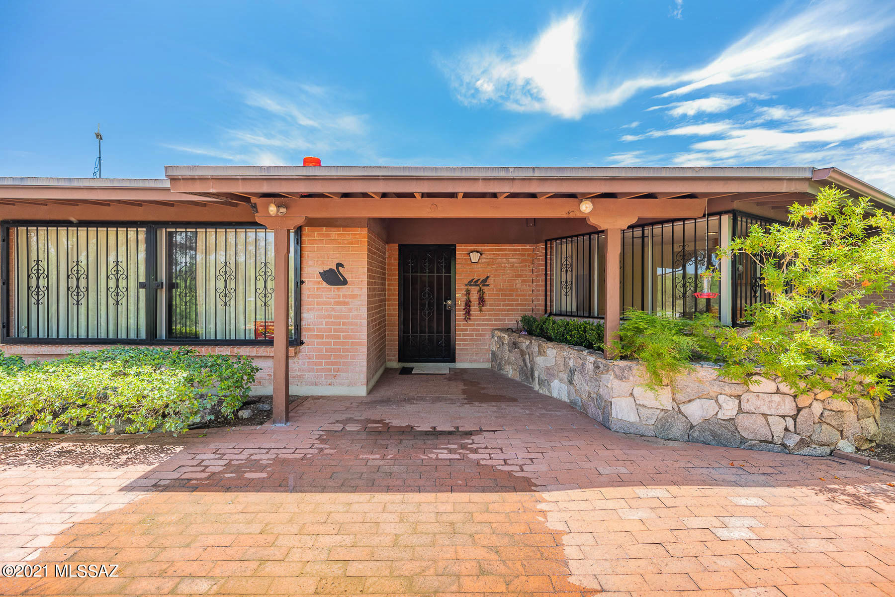 Gated long driveway leads you to this secluded and charming custom brick Mid-century home on 4.55 dividable acres in the Foothills of North Tucson.  Spectacular views of the mountains and city from various parts of this pristine natural property. This is a rare opportunity to own one of the last large parcels in the Foothills! Listed at current appraised value.
