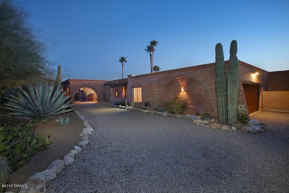 An impeccable burnt adobe territorial on a premium view lot high-up in gated Sin Vacas. Spacious living areas are complemented by sweeping city and Catalina Mountain views. The superb updated kitchen-newer Mesquite cabinets, granite counters, premium stainless appliances, 2 breakfast bars - is open to a generous sized family room and casual dining area - all with mesmerizing city views. Party sized covered patio overlooks the pool and city lights beyond. Classic details throughout - with portico drive/entry, wood beamed ceilings, talavera tile, Saltillo floors. Master Suite with fireplace, private patio and spa tub-adjacent office (could be 4th bedroom) Two bedrooms & bath at opposite side of home with game room. Laundry+bonus/exercise/ craft room complete this stunning home.