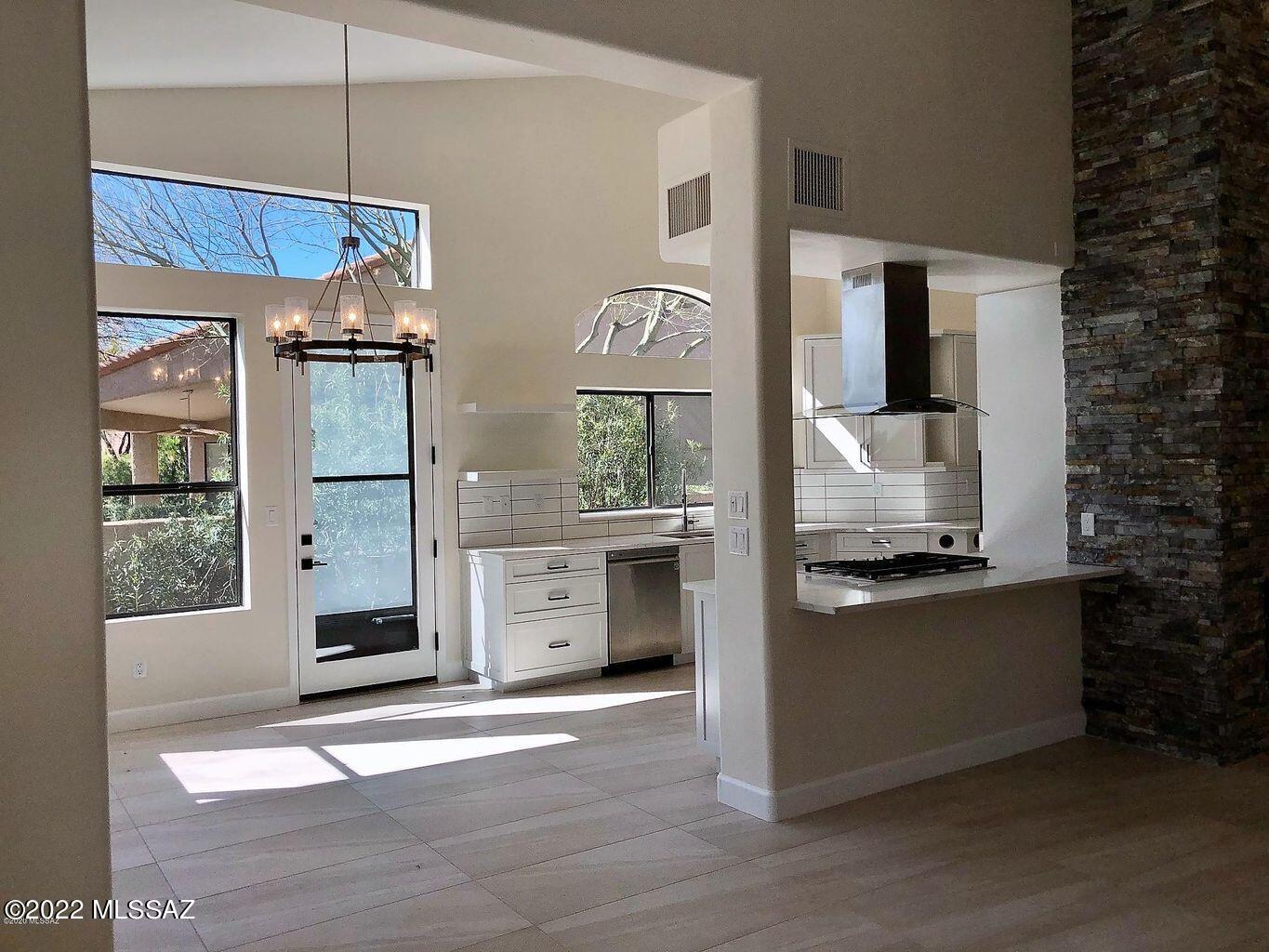 Simply Sublime, Shows like New!  Floor to Ceiling Renovation 2020, beautifully executed with all the top quality design features you'd want in your Ventana CC Golf Villa.   No steps/stairs!  Sleek, Modern Kitchen opens to an Impressive Great Room, new  custom bar & built-ins, offset by a Stacked Stone gas Fireplace.  Expansive Quartz Surfaces, Custom Cabinets and Stunning Tile throughout.  3rd Bedroom with New, Built-in Home Office.  Luxurious Master Bathroom, with an emphasis on Natural Light, features a large Walk-in Shower with Glass Surround & Garden Tub.  Northeast facing Patio offers Privacy and a peek-a-boo Mountain View, complete with New Built-in Gas Grill.  2020 Zoned HVAC & Water Heater.  Over $12,000 in Window Coverings.  One of the best Golf Villas on the market this year.