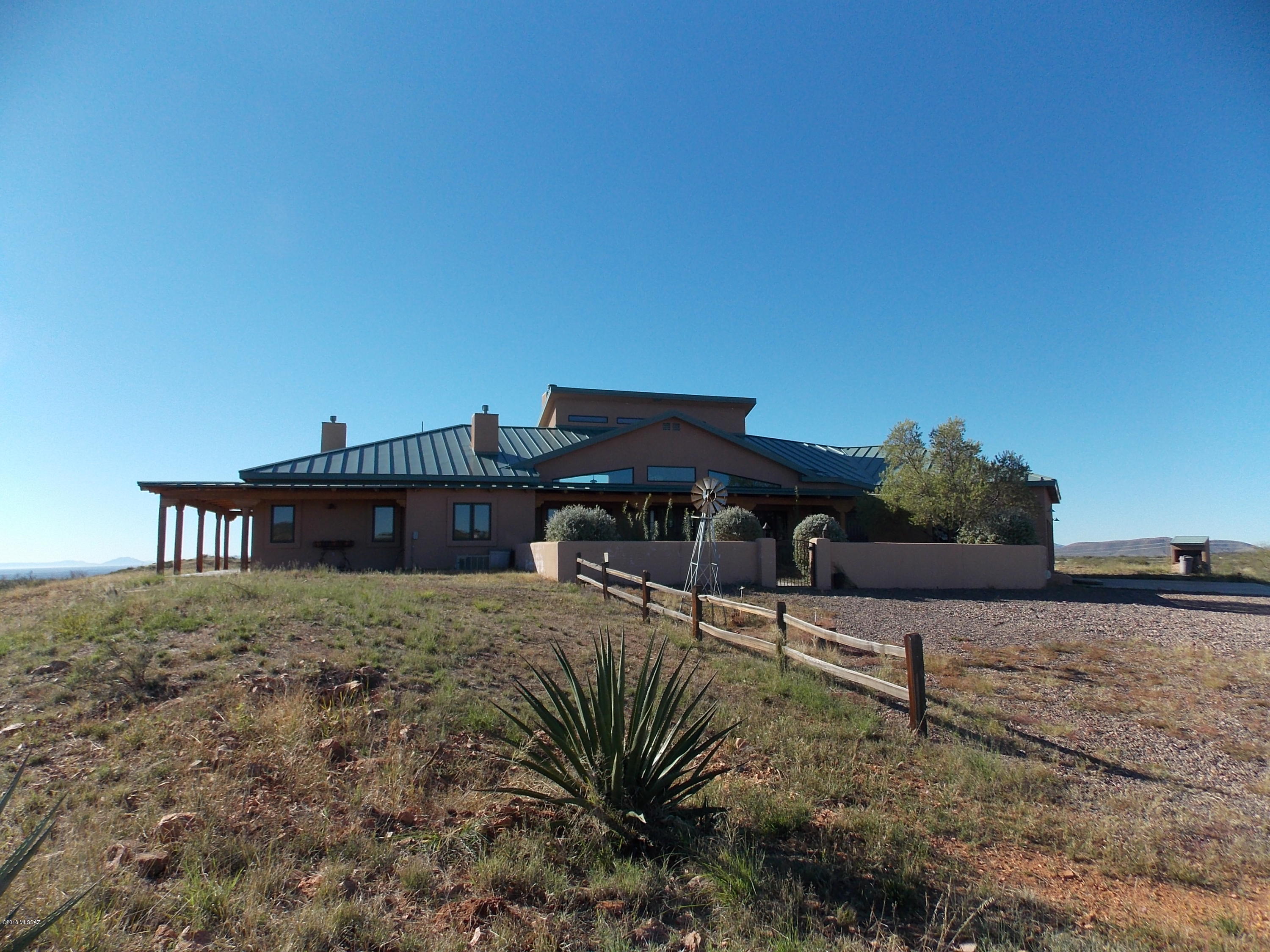 Privacy, elegance and room to roam! This 117 acre 3bdrm, 4ba, 3 car garage home features:  A breathtaking 360degree mountain and valley view.  The main house is 3296sqft with a 648sqft guest house. Private well,standing seam metal roof with 2264sqft under porch, The chef's kitchen features cork flooring, granite counter tops, custom cherry wood cabinets, self closing drawers, 2  stainless prep and farm sinks,Viking dual fuel 48'' range, microwave drawer, walk-in Kitchen pantry,   Laundry room, storage room, mud room, storage galore, water softener, large master bedroom with walk-in closet, gas fireplace,  and exercise room, master bath has a walk-in shower, free standing air-bath. on suite Guest bedroom. One bedroom guest house with fireplace & laundry. Barn and a metal shop, see more inf 3 stall barn with tack/feed room, covered shade on the south side that opens into a larger corral, hay storage inside the barn for easy feeding, fenced and cross fenced