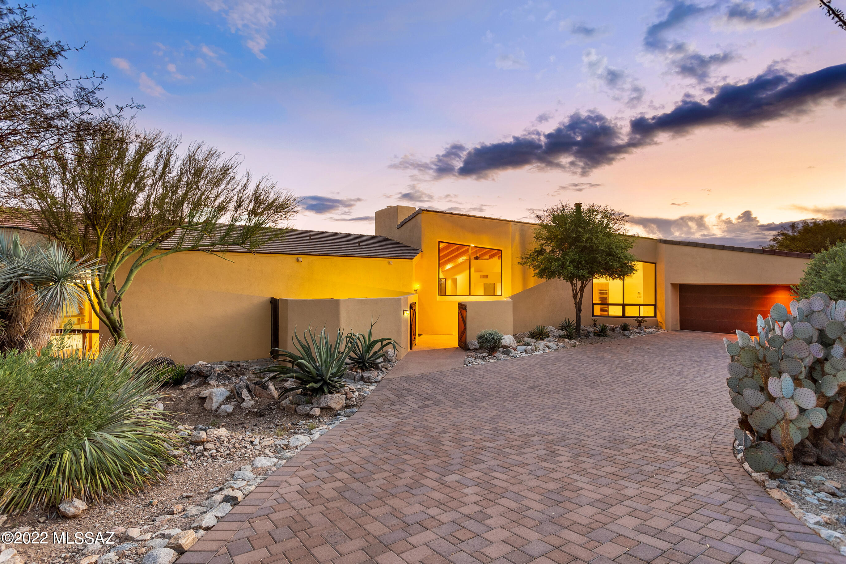 Fabulous Mountain and City views from this one owner home located in the exclusive guard gated Sin Vacas! 
Nestled in the Catalina Mountains sits this warm and inviting 3BR / 3BA 3153 SFhome. Wall of windows and high ceilings with exposed beams are just the beginning of how special this home truly is. Great room with fireplace and separate dining area off the kitchen. Open floor plan is perfect for entertaining. Back yard has endless views with privacy. New enhancements you will appreciate are new HVAC units, Primary and second bathroom recently updated, exterior paint (Sept 2022) and brick pavers on the driveway! See features list for more info. Large 3 car garage w/ storage & bonus room! Conveniently located to restaurants shopping and more!