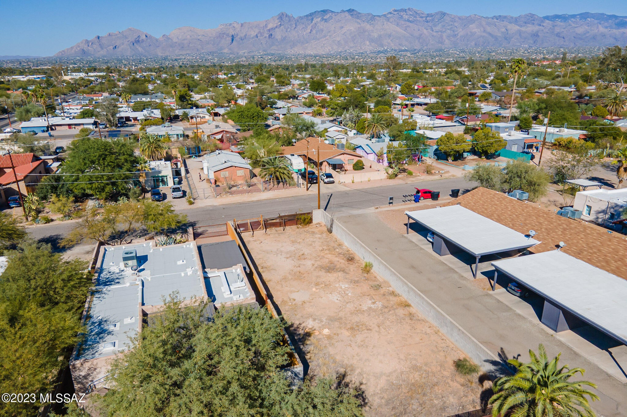 Mountain views in Historic Blenman Elm, where vacant lots are rarely found. This charming neighborhood showcases architectural styles and historical significance, all while enjoying the convenience of a central location. Stroll to the Arizona Inn, Himmel Park, the University of Arizona, and Banner Medical Center from this desirable area. Privacy is assured with block walls lining each of the property's two long sides. With no HOA constraints, the R2 zoning allows for the construction of a single or multi-family residence, catering to those seeking a custom home or investment property. The lot comes complete with a survey and preliminary design for a 3-bedroom, 2-bathroom, 1700 sq ft house, both of which are included. Seize this exceptional chance to build in the highly coveted historic Blenman Elm, where opportunities like these are truly rare.