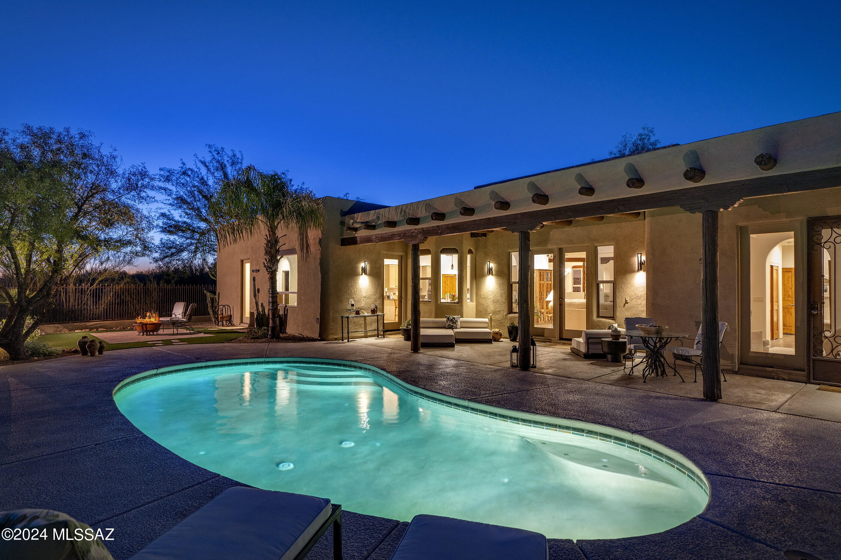 Nestled at the end of a cul-de-sac within Chaparral Heights on just over an acre premium lot, this TJ Bednar desert vernacular home embraces the harmony of light and space that embodies the epitome of the Arizona lifestyle. 

Elevate your entertaining experience in this open concept floor plan adorned with soaring ceiling heights and seamless indoor and outdoor living. Warm Viga beam ceilings, Knotty alder doors, and complementary tile floors provide a cohesive interior design and a timeless foundation, while meticulously chosen fixtures and finishes enhance every corner.

Indulge your culinary passions in the chef's kitchen outfitted with new stainless professional series appliances, featuring striking granite countertops and custom cabinetry providing ample task space. The primary suite is sequestered on the east end of the residence, with french doors that spill out onto the private rear veranda. The primary bath has a spacious walk-in shower, soaking tub, dual vanities, and nearby large dressing suite. Situated on the west wing of the residence, and perfectly suited for guests or family alike, are three supplementary bedrooms. 

A large covered veranda captures the romance of the southwestern desert, running the length of the southern edge of the residence. French glass doors opposite the statement Beehive fireplace provide seamless flow from the interior to the exterior of the living room, creating an extension of the outdoor living space. Drifts of colorful landscapes highlight the pool, serving as a vibrant counterpoint to the surrounding foliage, with eastern exposure encompassing sweeping view corridors framing Pusch Ridge and the Catalina Mountain ranges. This timeless design is thoughtfully executed and perfectly scaled for private and comfortable everyday living. From this desirable Oro Valley location, one is just moments away from top-tier restaurants, shopping, golfing, hiking, cycling, tennis, and pickleball opportunities.