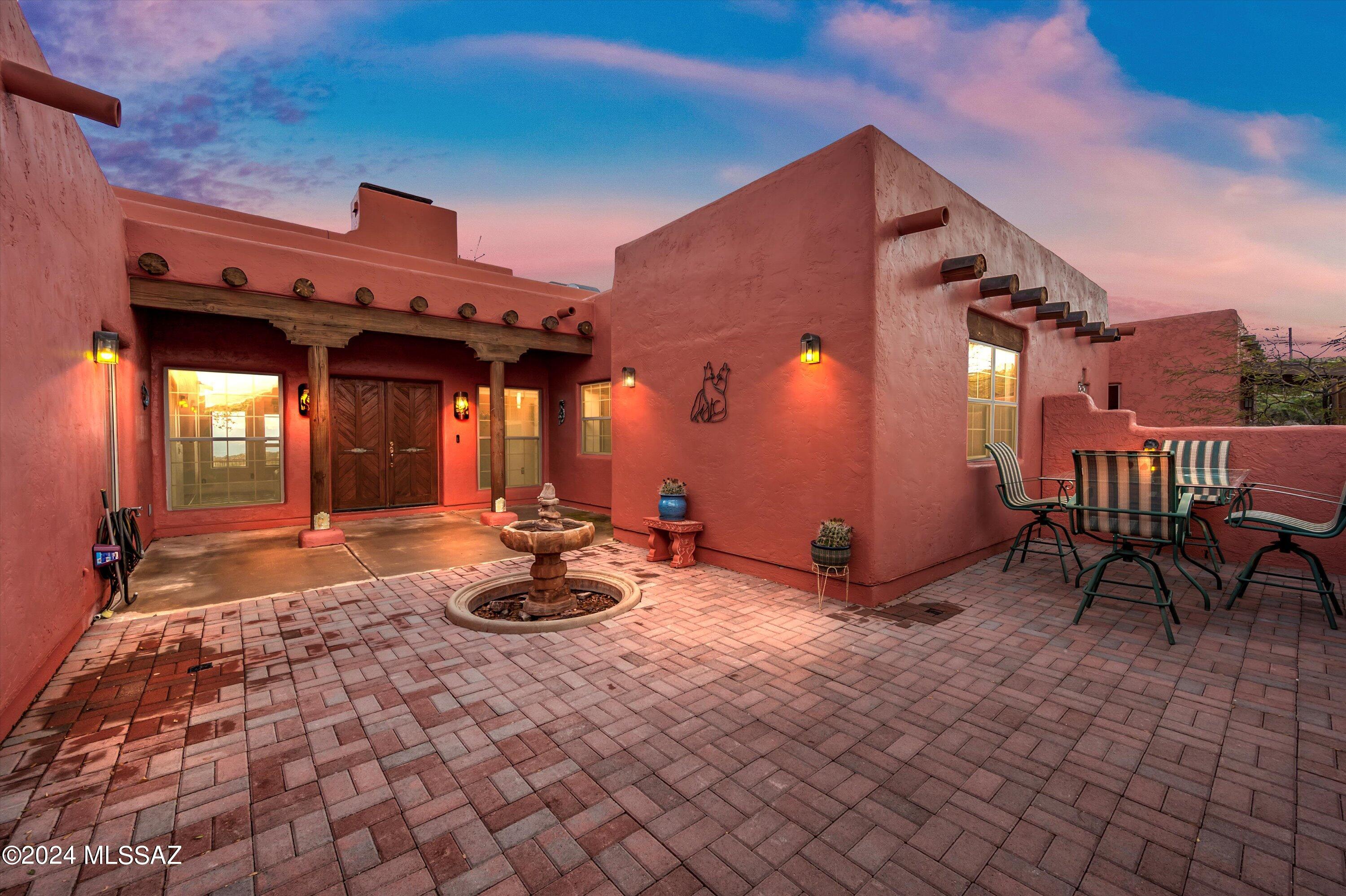 This stunning custom built hilltop Santa Fe home has breath taking mountain views and surrounds itself with mature oak trees, manzanita and boulders. Huge picture windows facing east and showcasing the Guilarro Mountains with gorgeous sunrises. Natures canvas! It also has a separate 2 car garage with separate electric meter and a 225 sqft studio/office and all of this on 3.50 acres.  High ceilings with exposed beams, central vacuum, new AC, hot water circulating system & timer, fireplaces, jetted tub, surround sound throughout the home and so much more. And just feet away from the Coronado National trail. Must see in person. With these views nestled in historic small-town Oracle, this beauty will not last long.